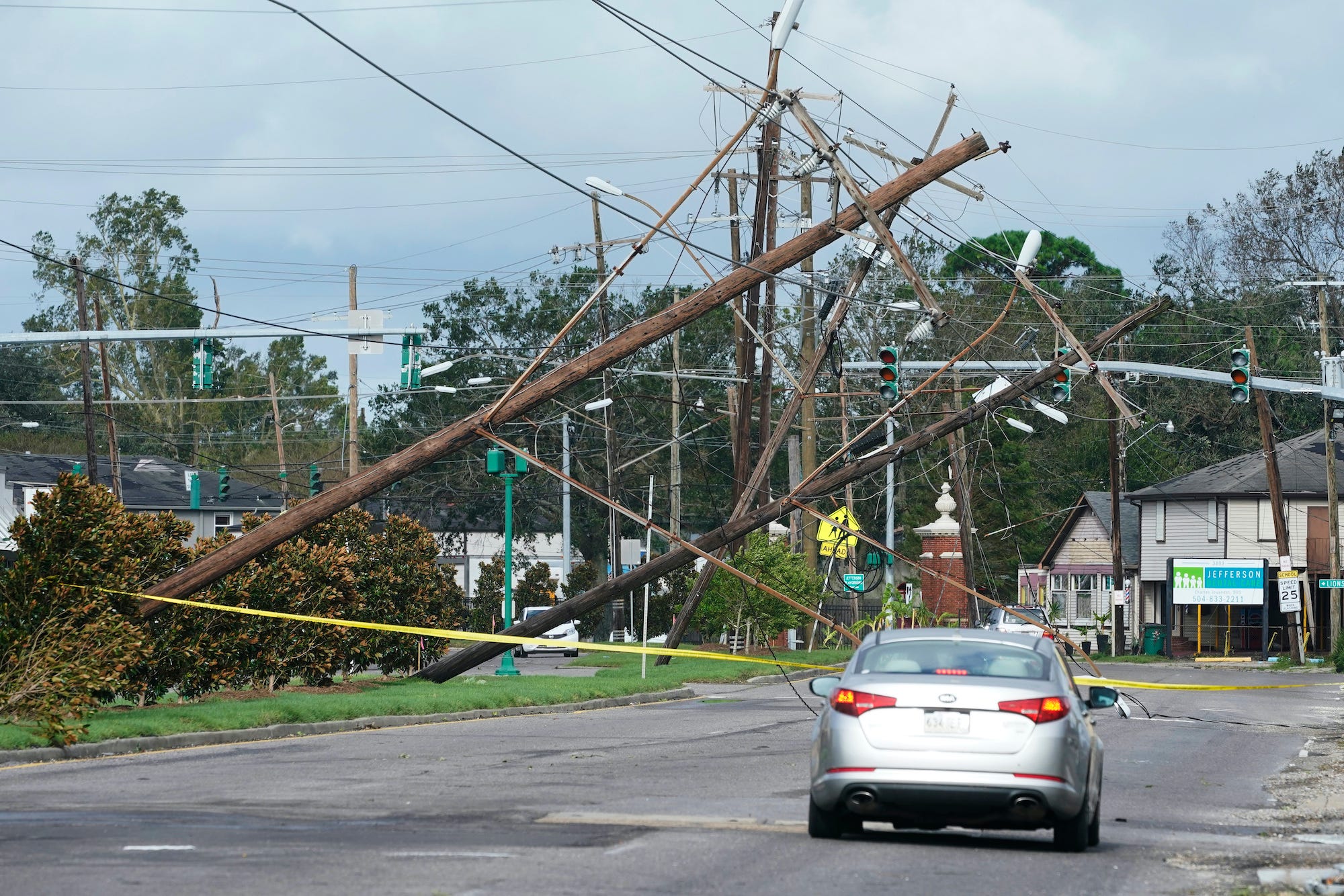 Downed power lines and a car on a street