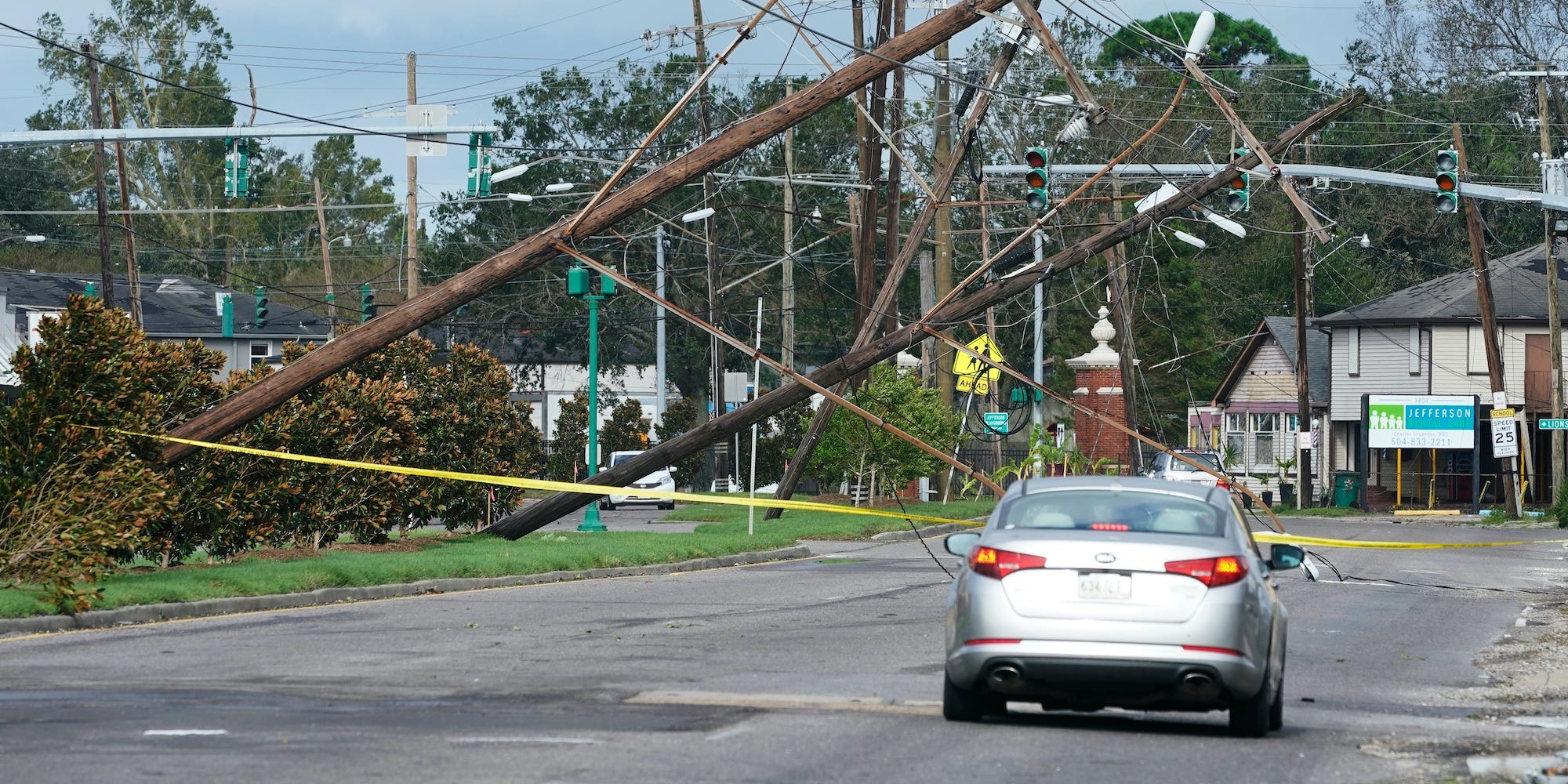 Downed power lines and a car on a street