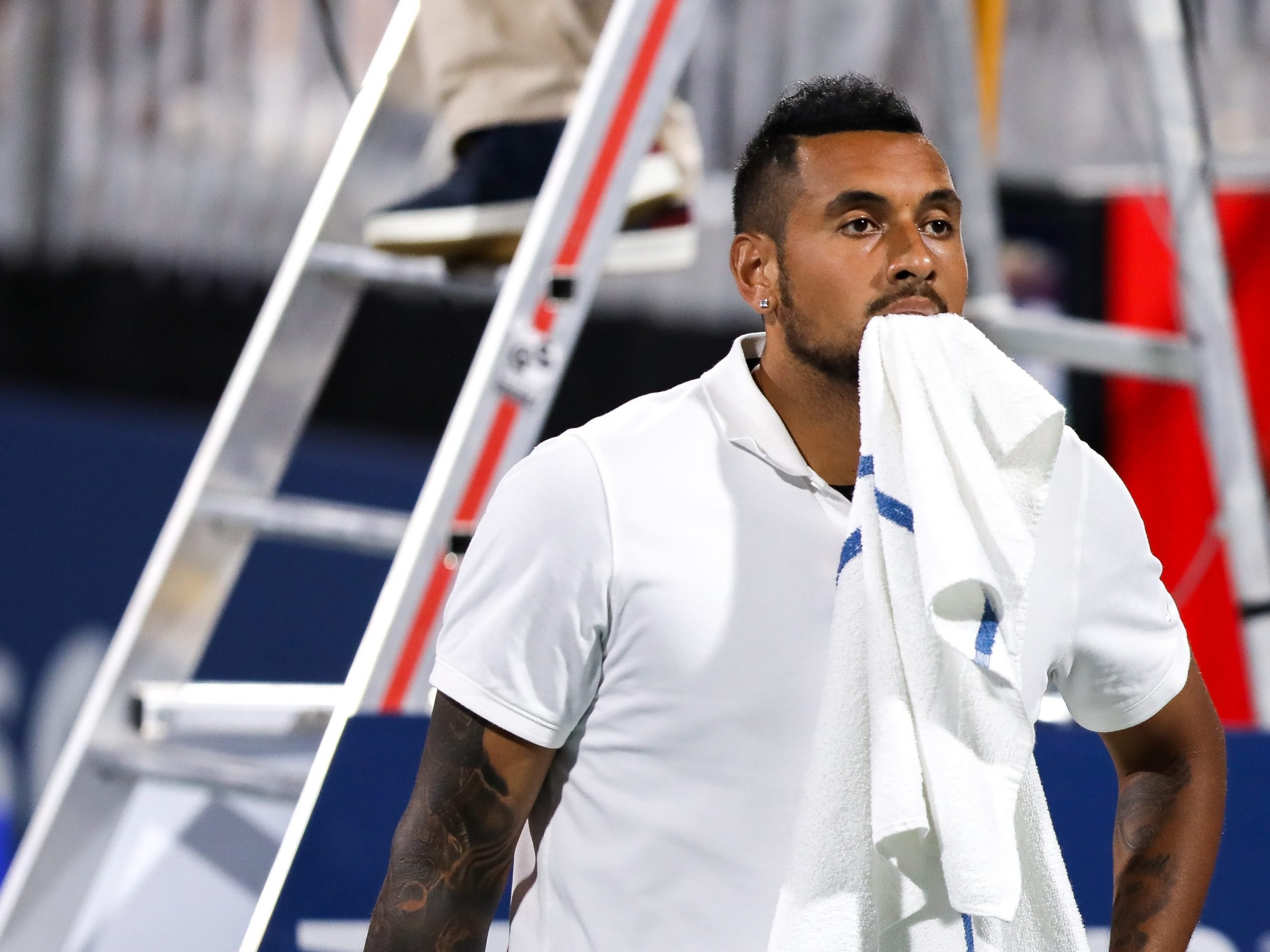 Nick Kyrgios bites into a towel at the US Open