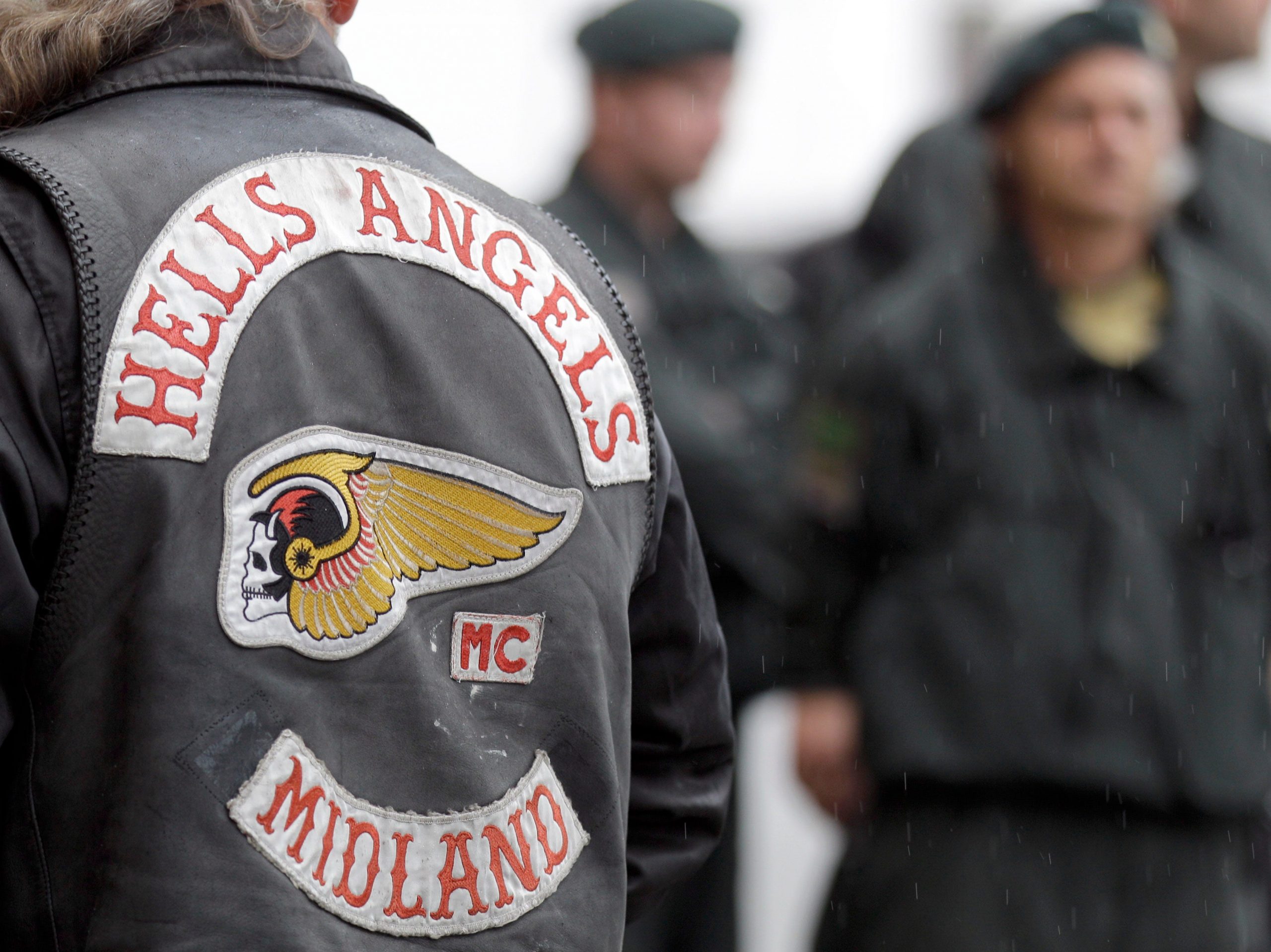 A man wears a Hells Angels jacket.