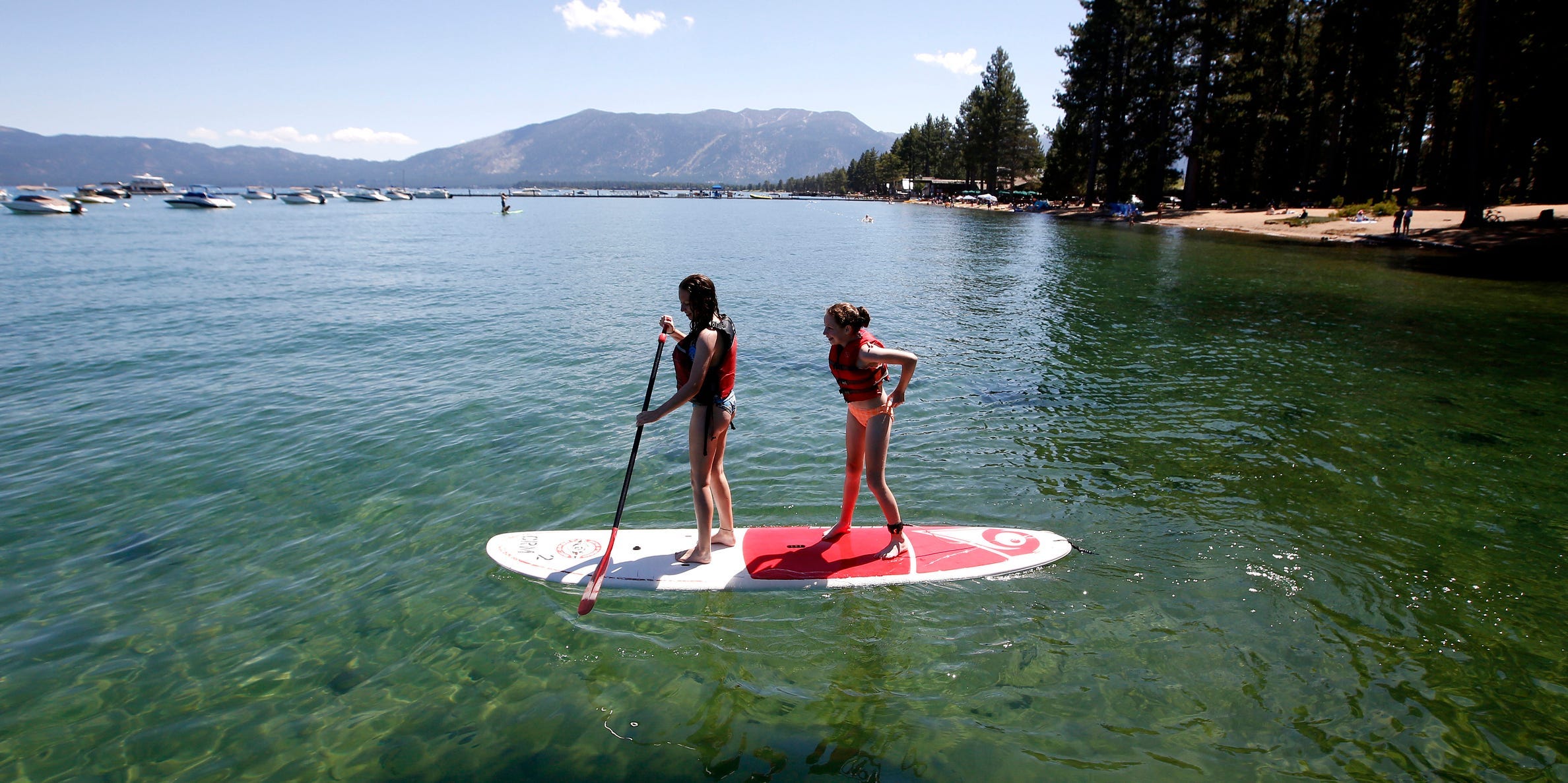 Two tourists paddle board on Lake Tahoe in 2019.