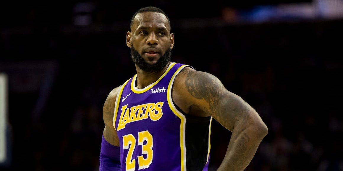LeBron James stands with his hands on his hips during a game.