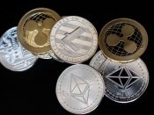 In this photo illustration of the litecoin, ripple and ethereum cryptocurrency 'altcoins' sit arranged for a photograph