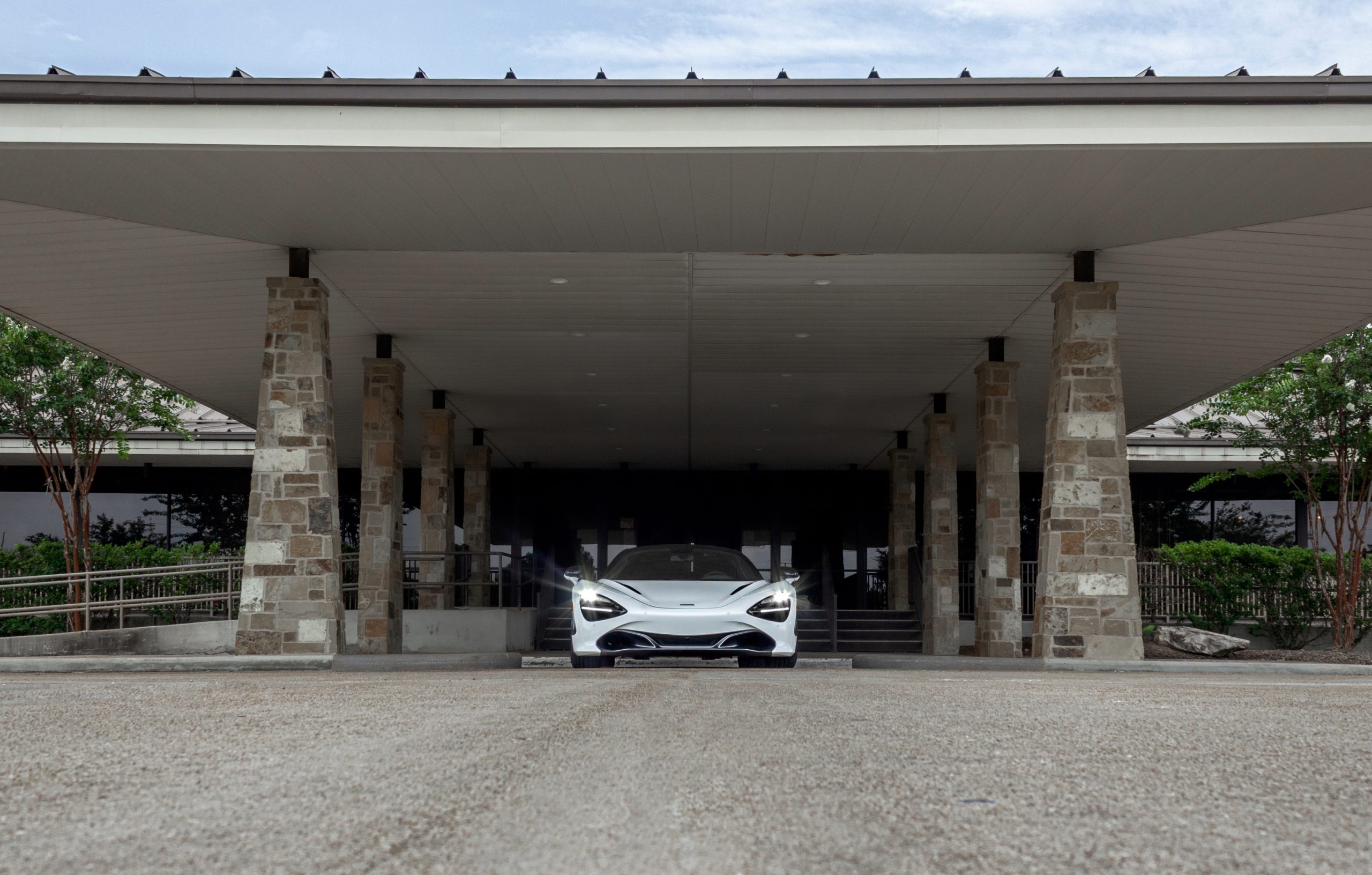 The McLaren 720S Spider under a dark awning.