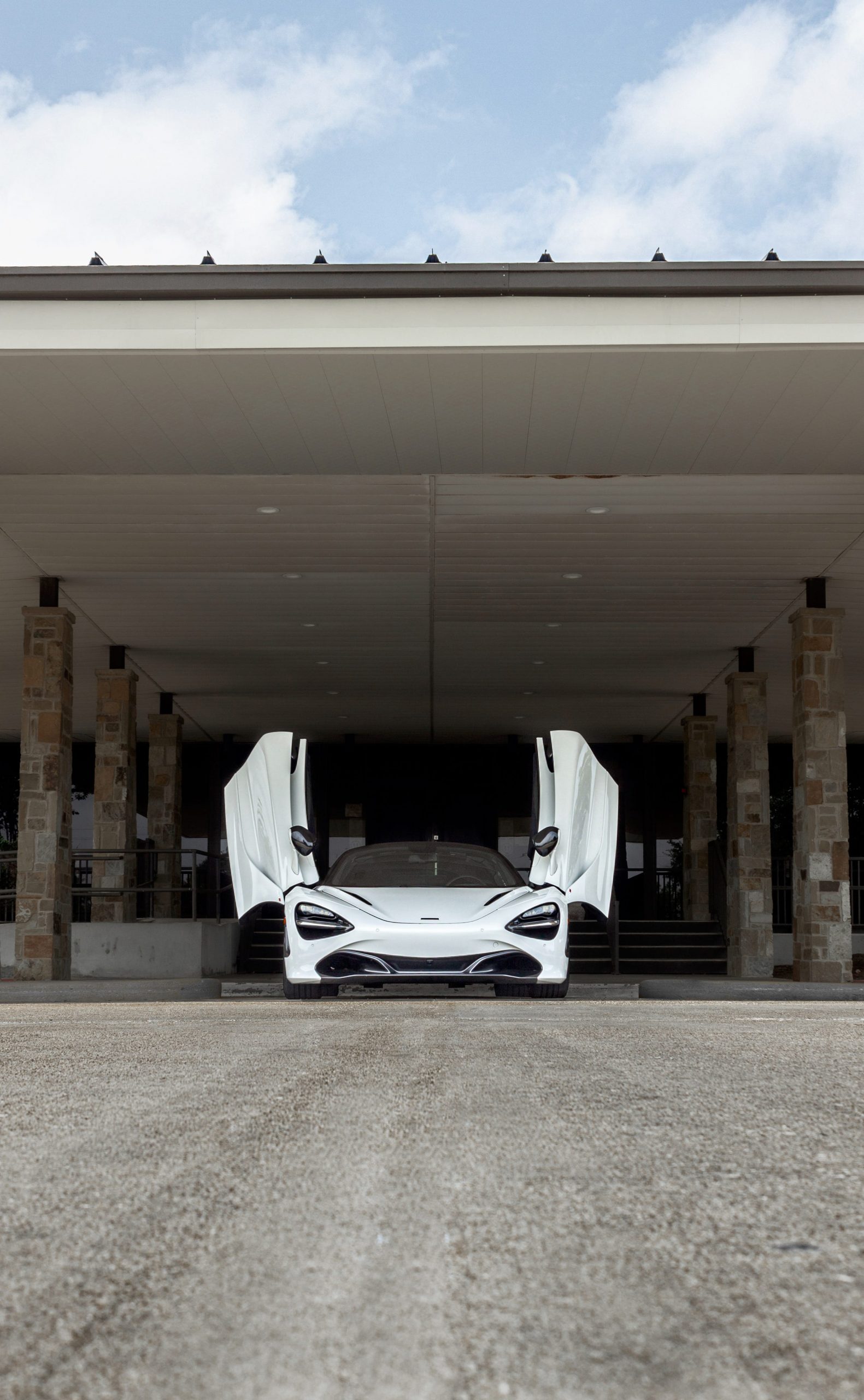 The McLaren 720S Spider under a dark awning.