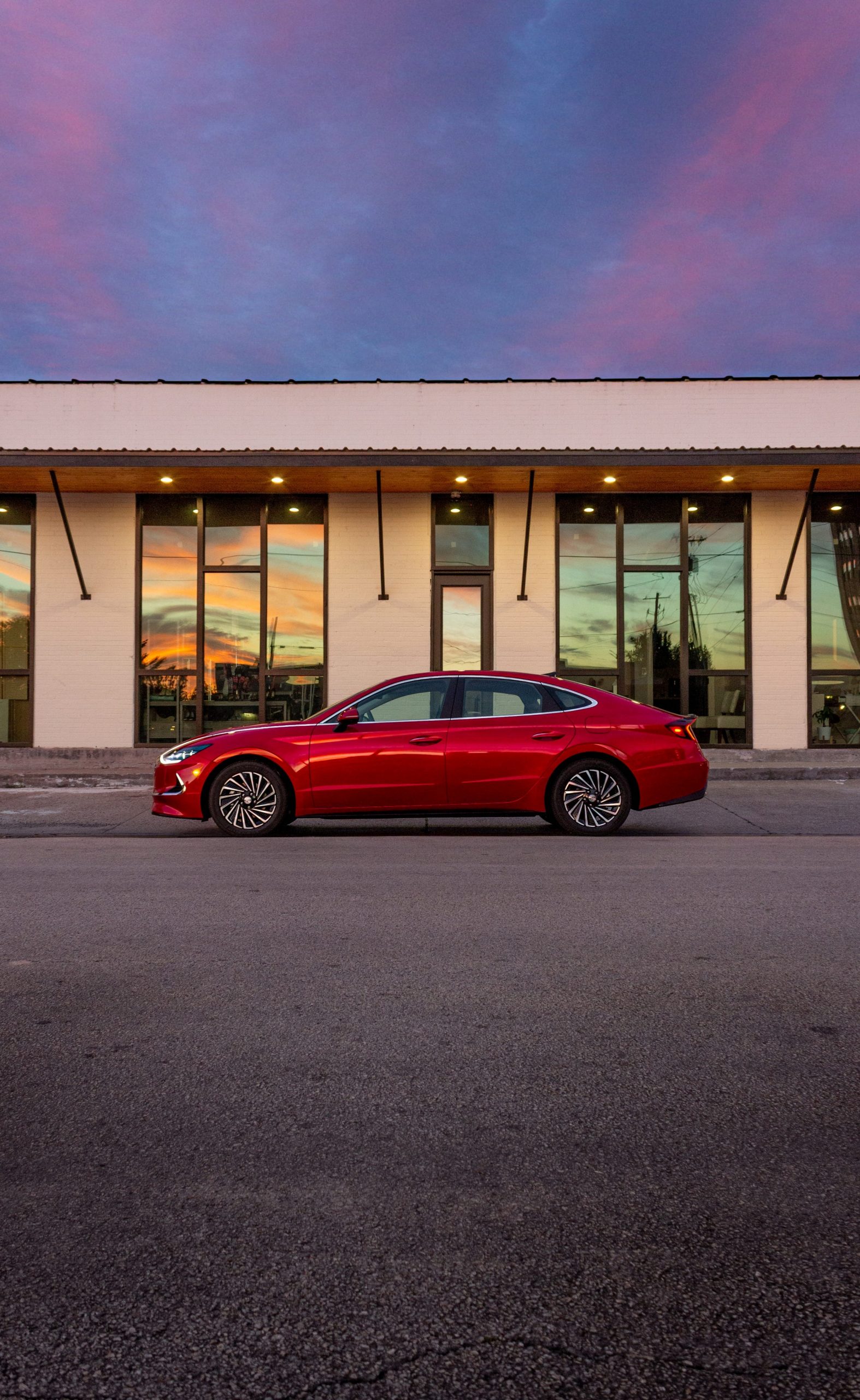 A red Hyundai Sonata at sunset.