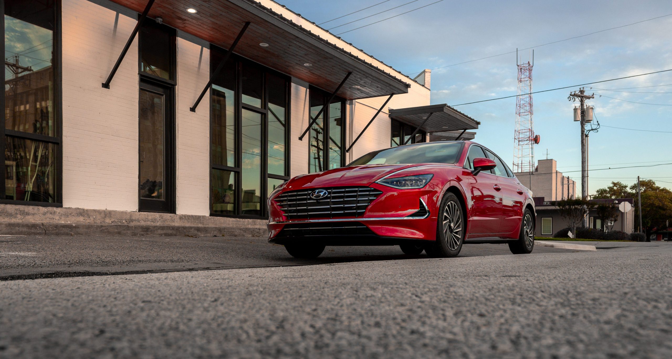 A red Hyundai Sonata near sunset.