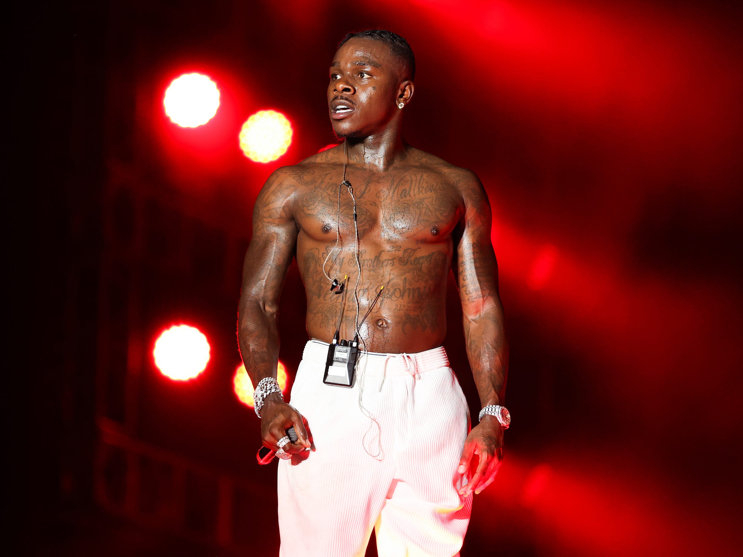 DaBaby onstage shirtless with red lights in background