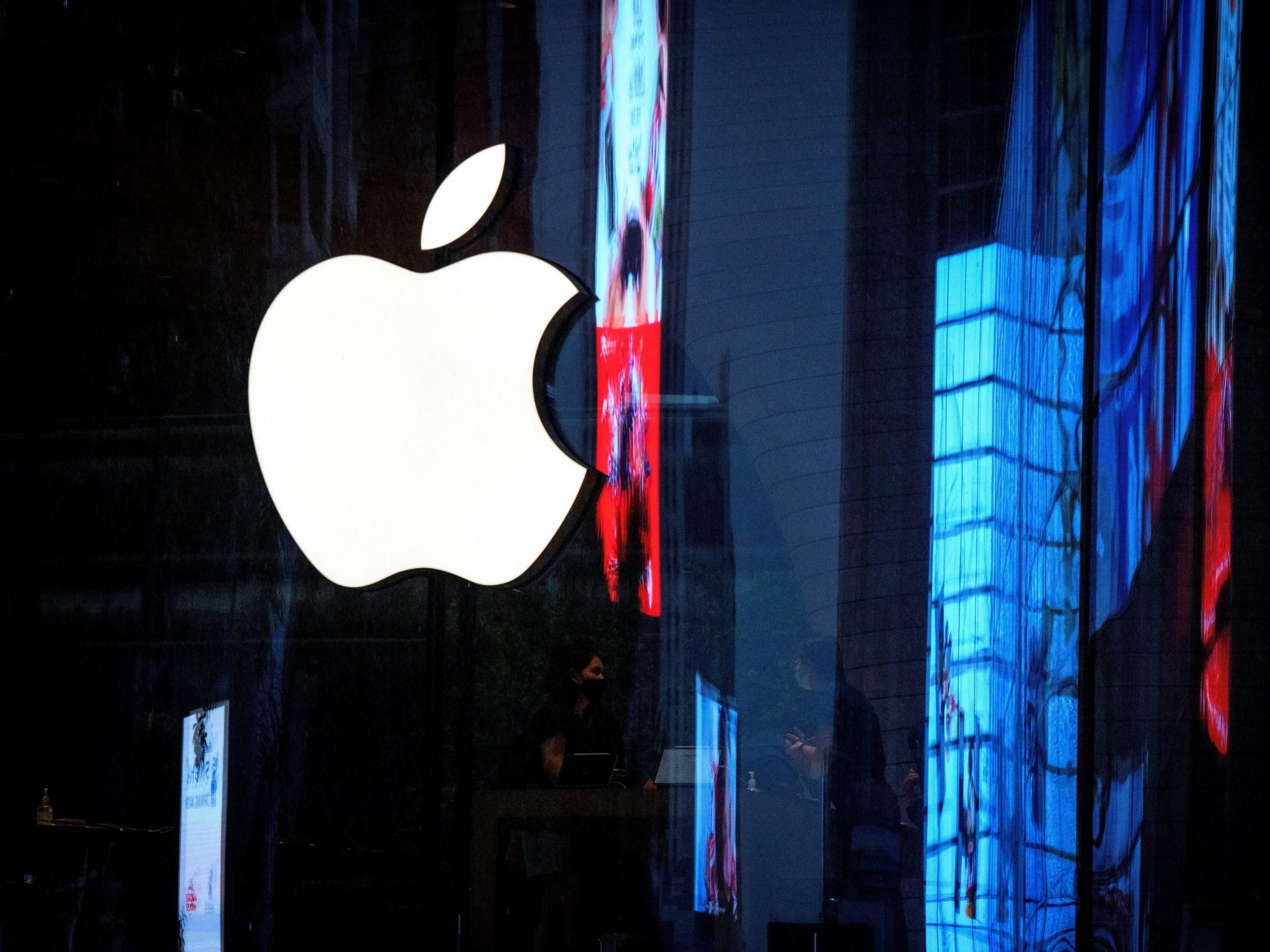 Apple logo in front of buildings