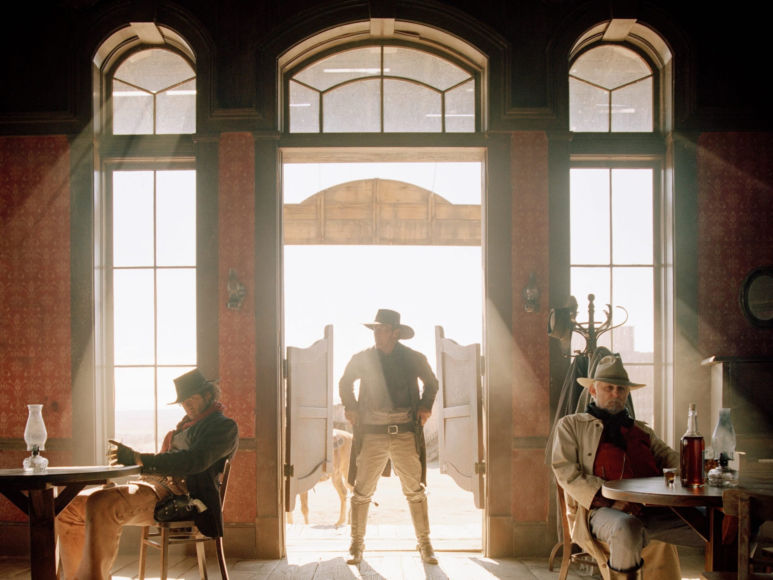 wild west imagery with a cowboy entering a saloon