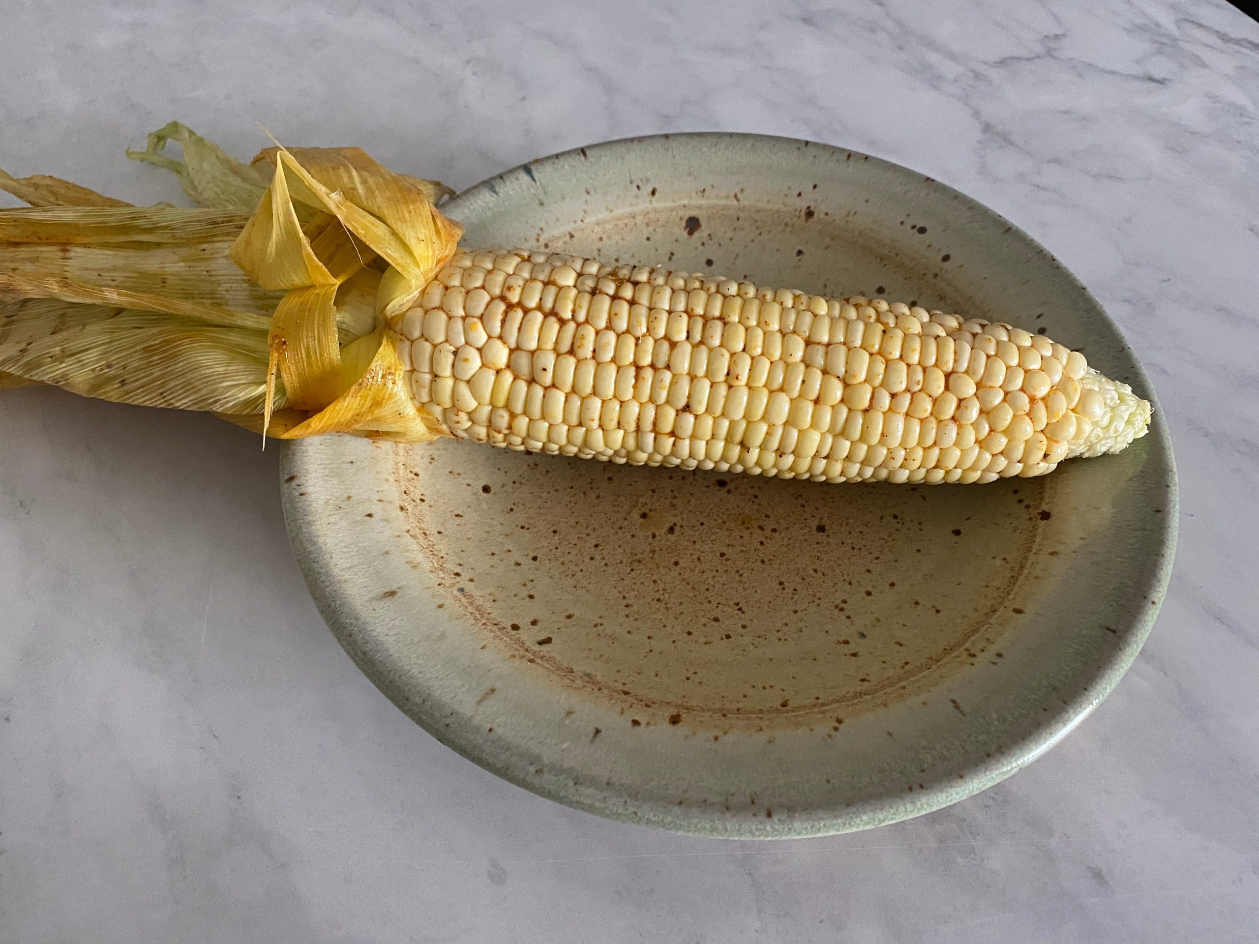 Corn on the cob on a plate.