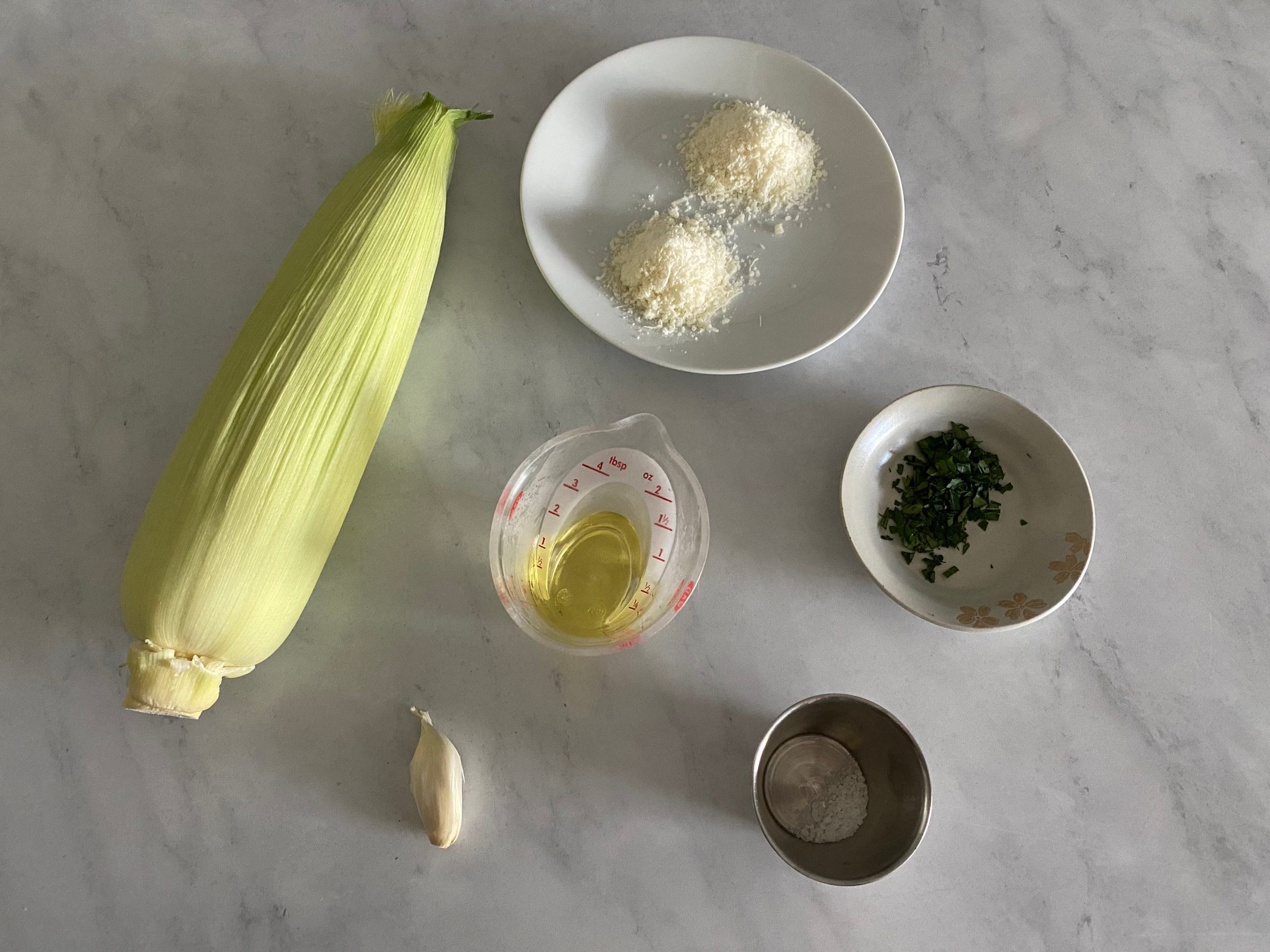 Corn, parmesan, parsley, olive oil, garlic, and salt.