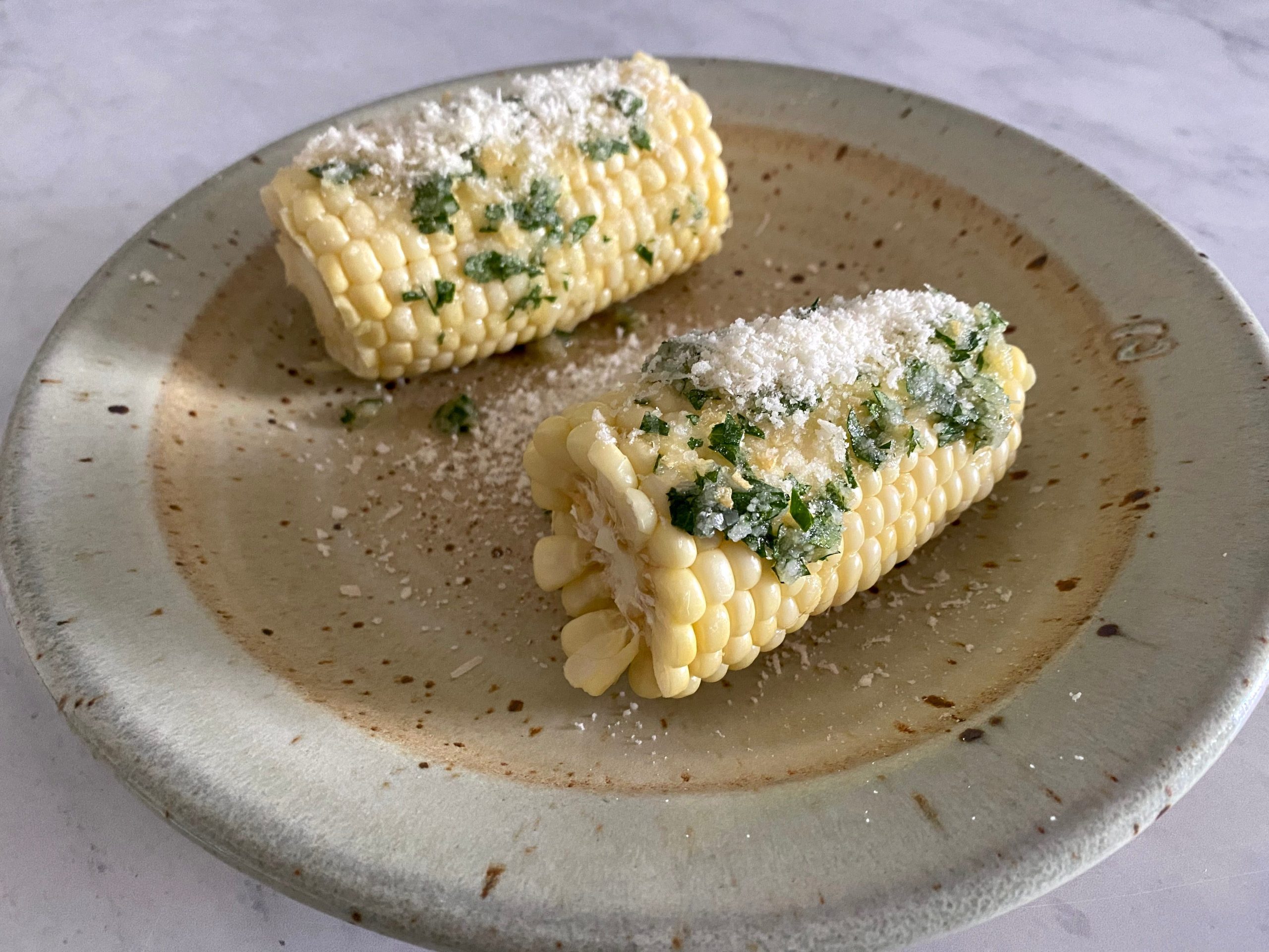 Corn on the cob with garlic and parmesan.