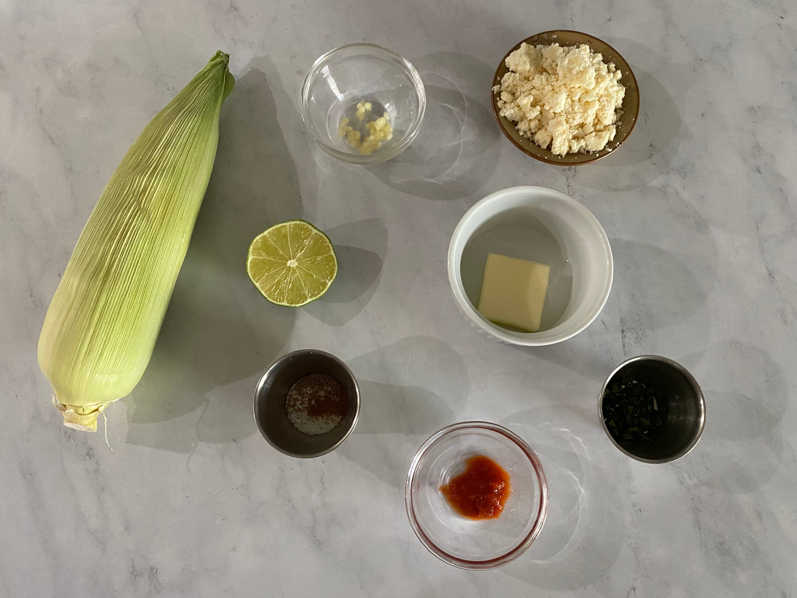 Corn on the cob, lime, butter, garlic, and rocoto paste.