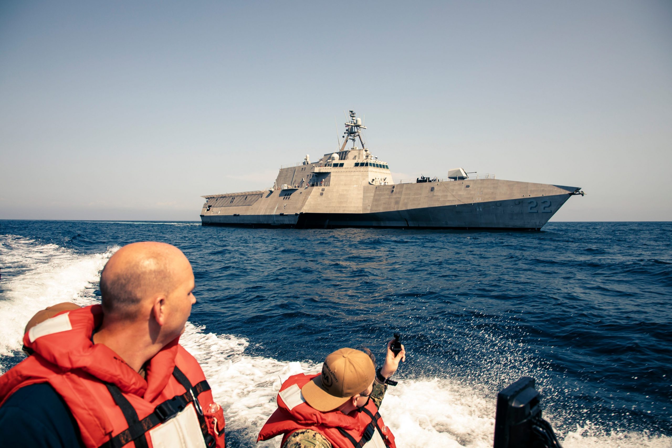 A view of the ship from a small boat with two men aboard