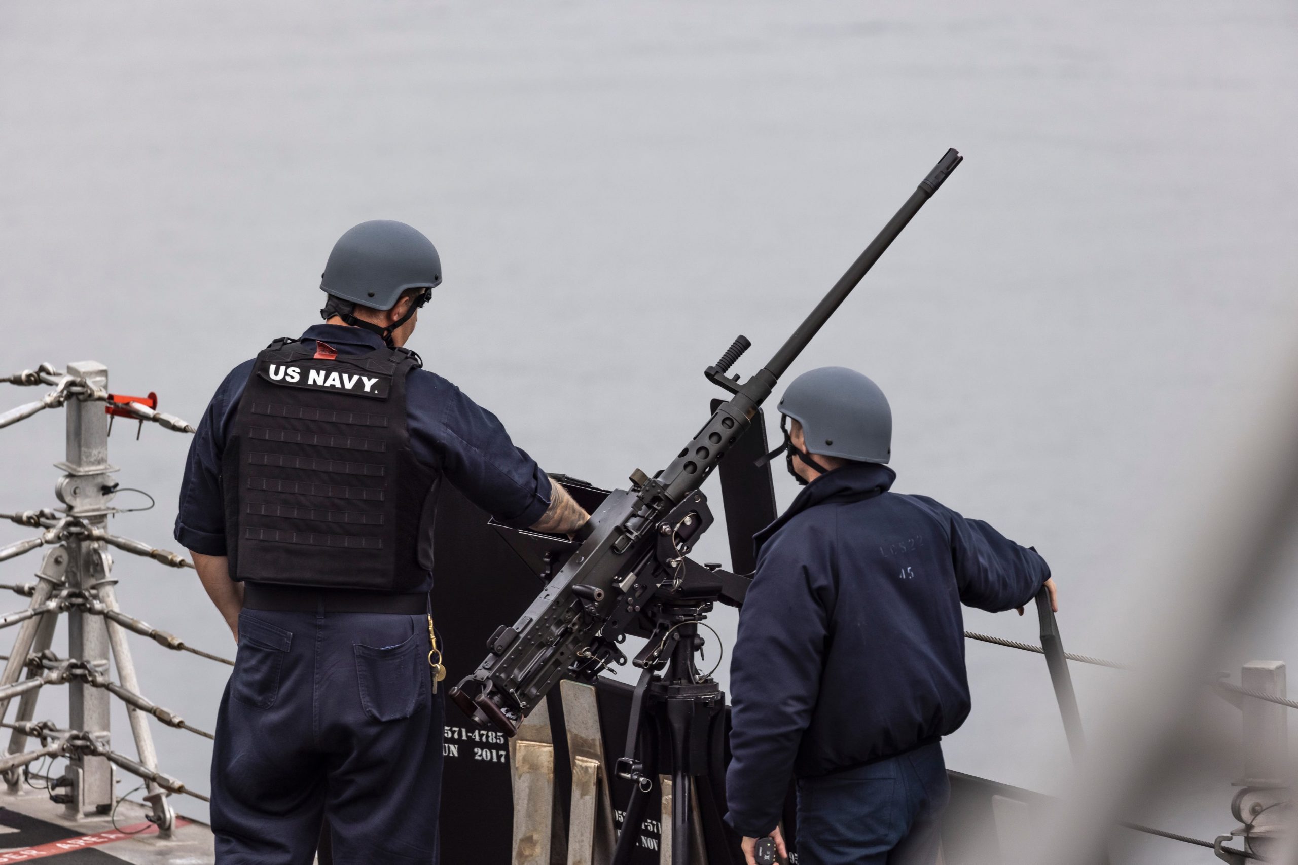 Crew members are seen manning the gun.