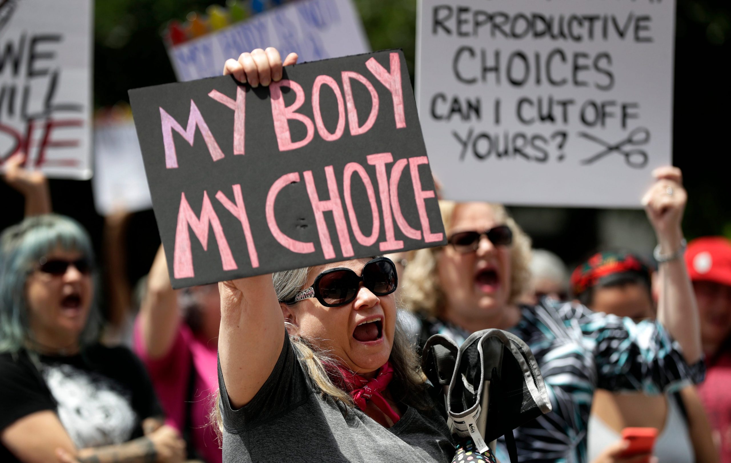 Protesters hold signs at an abortion rally at the Texas State Capitol in 2019.