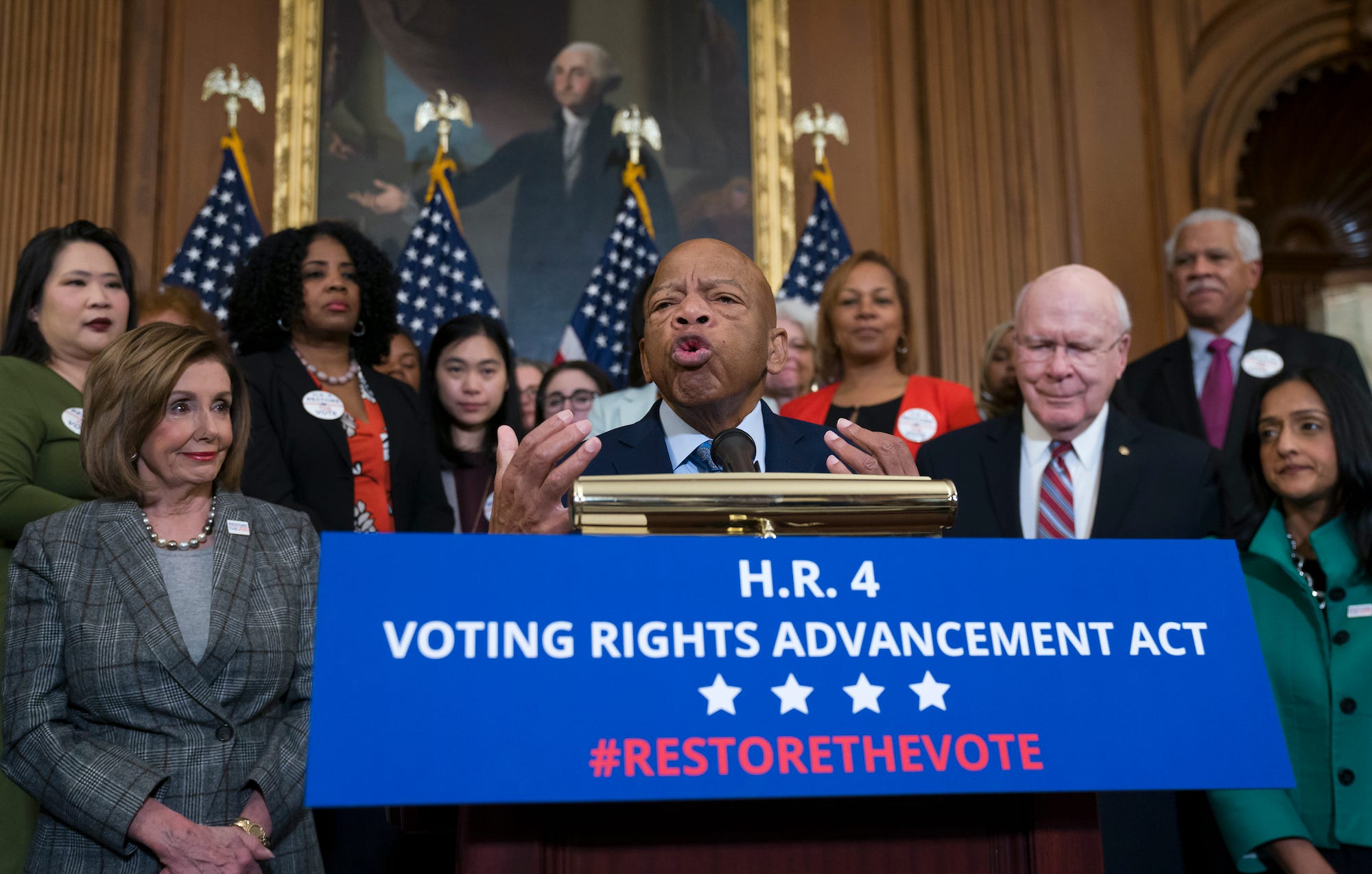 Civil rights leader Rep. John Lewis, D-Ga., flanked by Speaker of the House Nancy Pelosi, D-Calif., left, and Sen. Patrick Leahy, D-Vt., speaks at an event with House Democrats before passing the Voting Rights Advancement Act to eliminate potential state and local voter suppression laws, at the Capitol in Washington, Friday, Dec. 6, 2019.