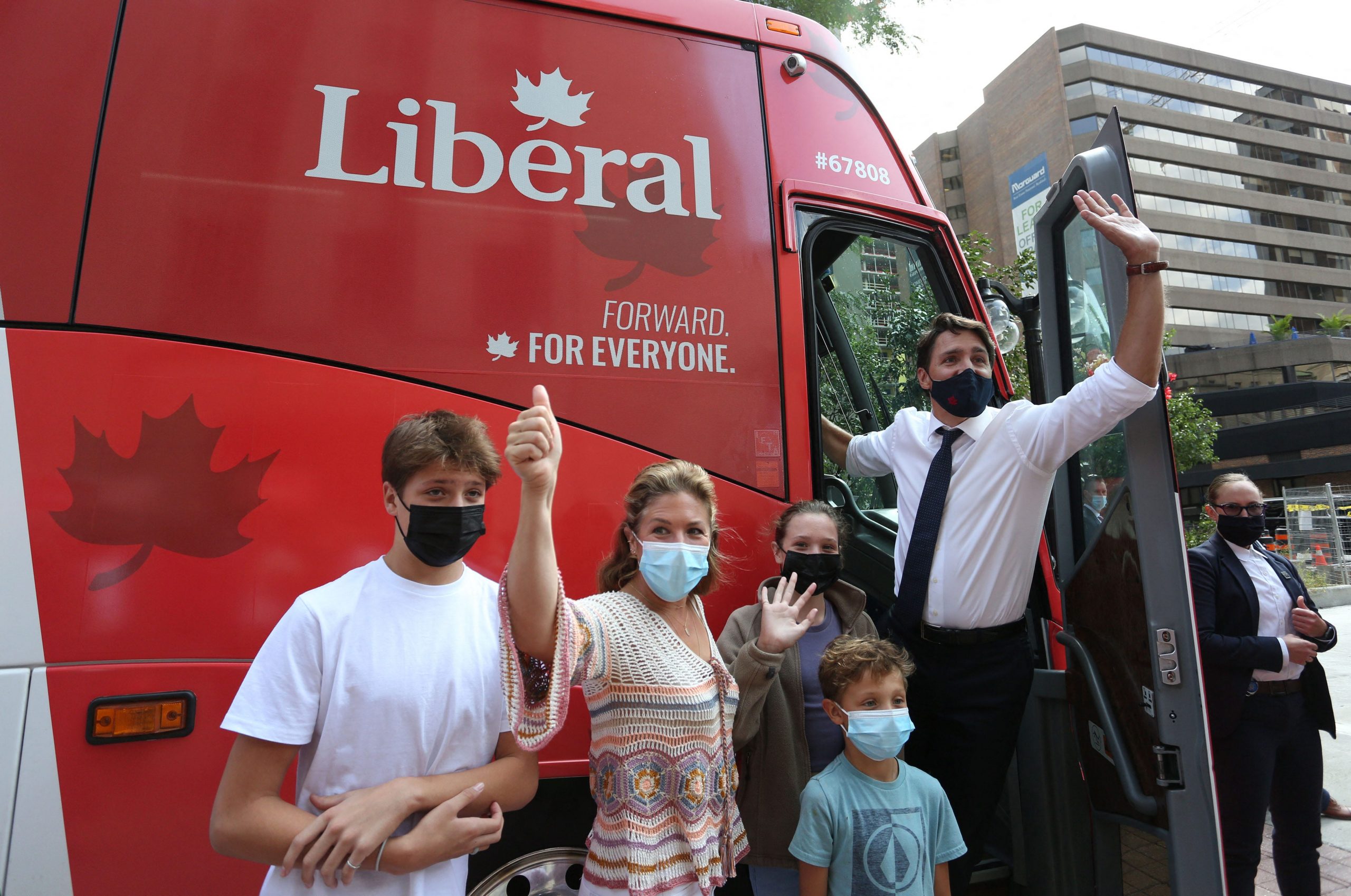 Canada's Prime Minister Justin Trudeau (R), his wife Sophie Gregoire Trudeau and their children Xavier (L-R), Ella-Grace and Hadrien waves to supporters while boarding his campaign bus on August 15, 2021 in Ottawa, Canada.