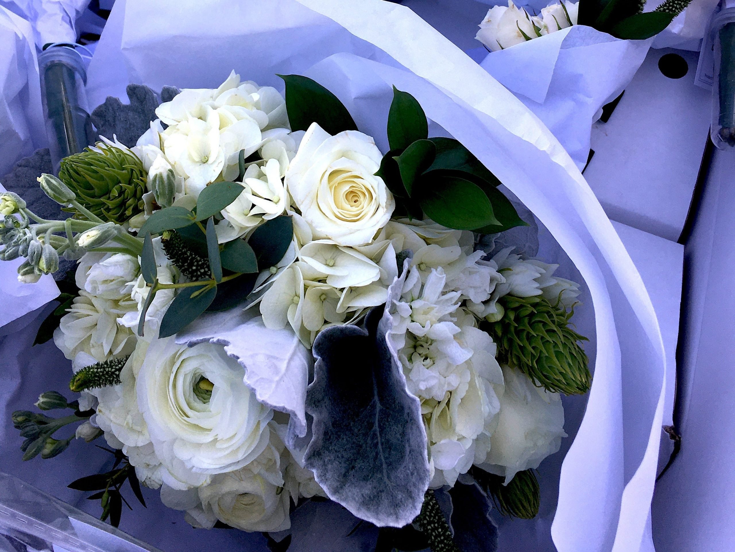 White flowers from Costco in a car.