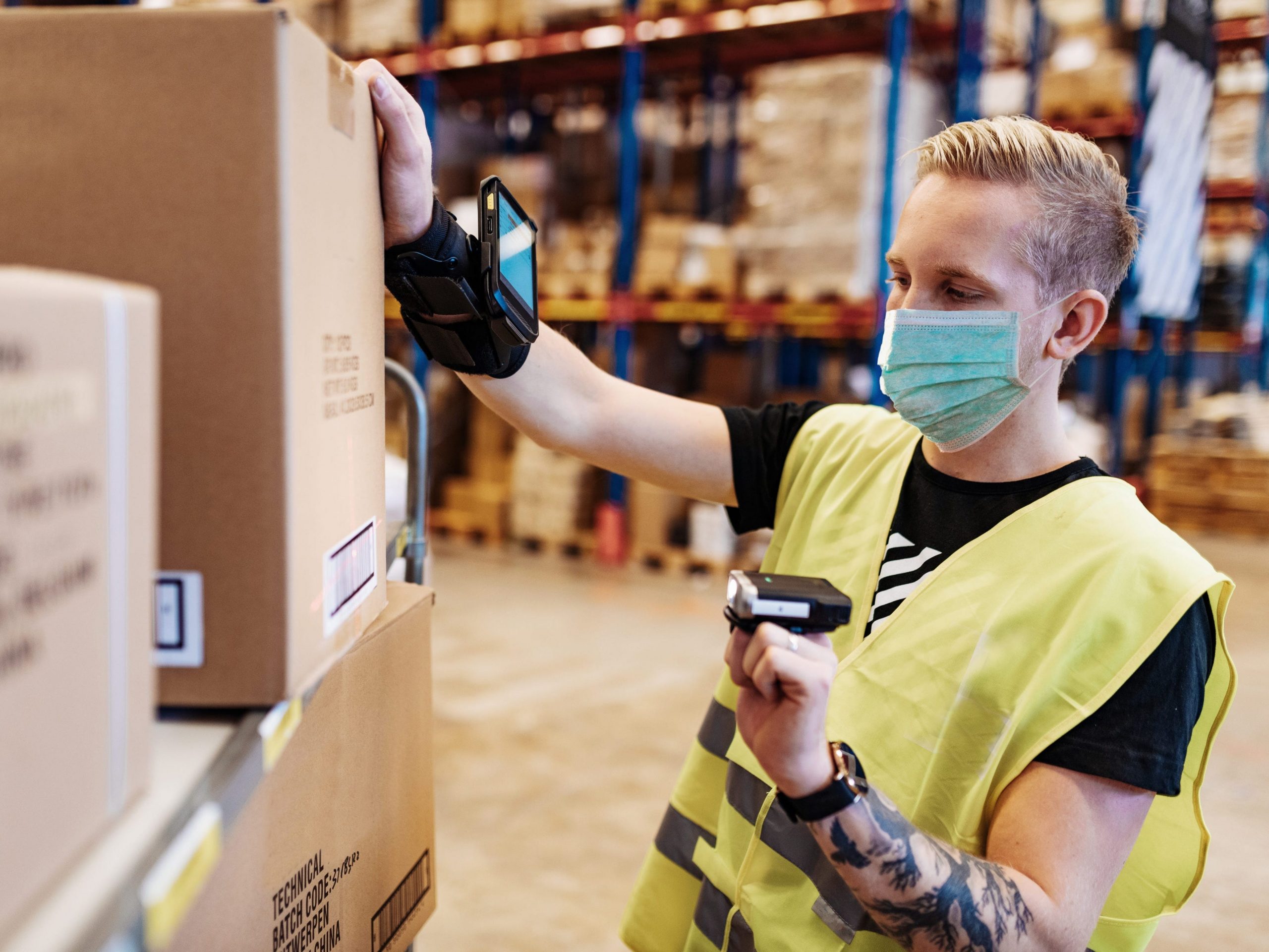 A warehouse worker scans a box