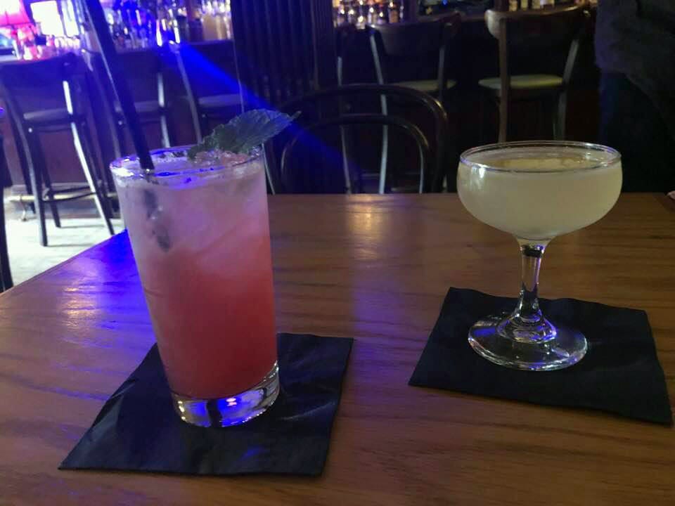 Two cocktails, one pink and one yellow, at Japp's