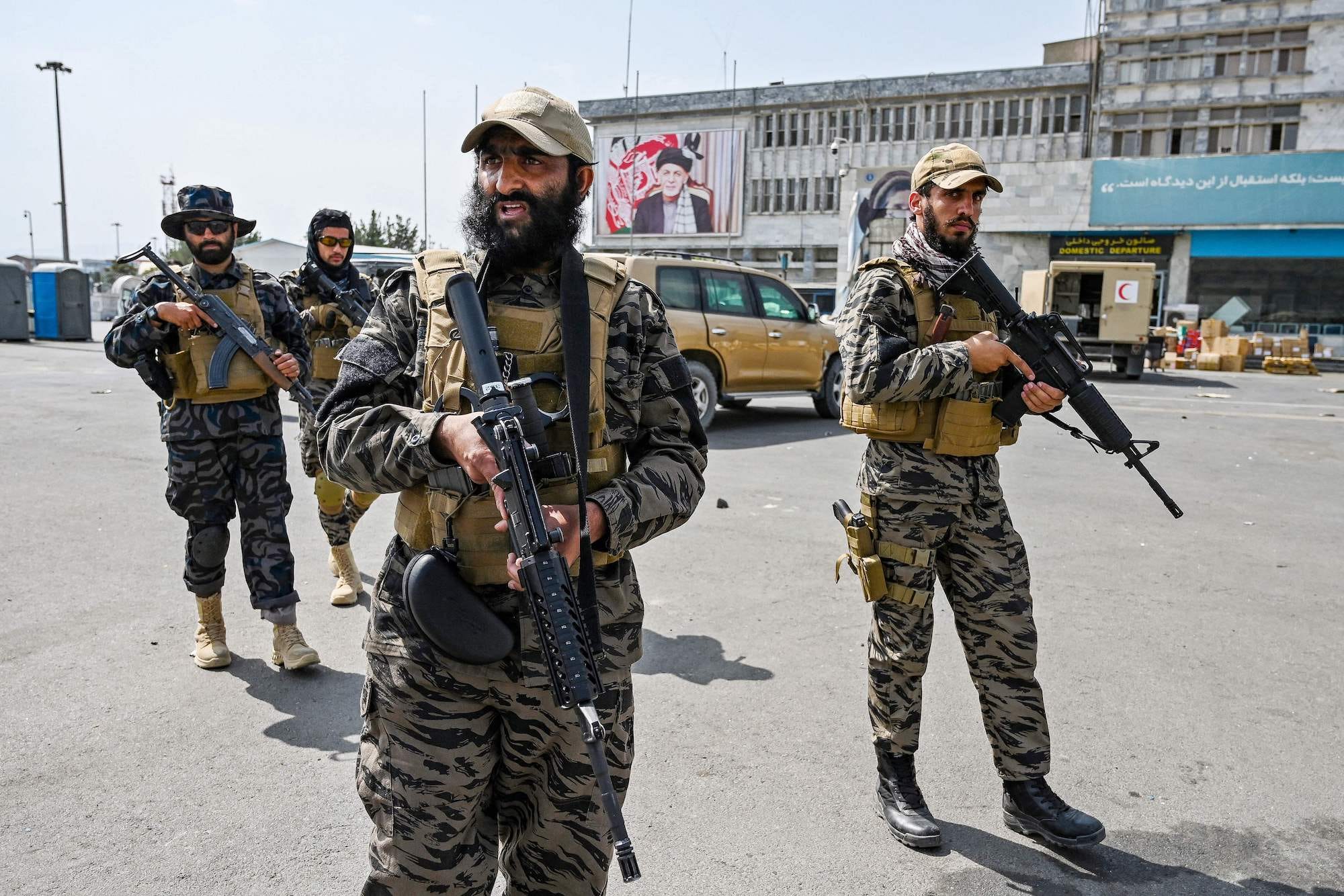 Taliban fighters with guns outside Kabul airport