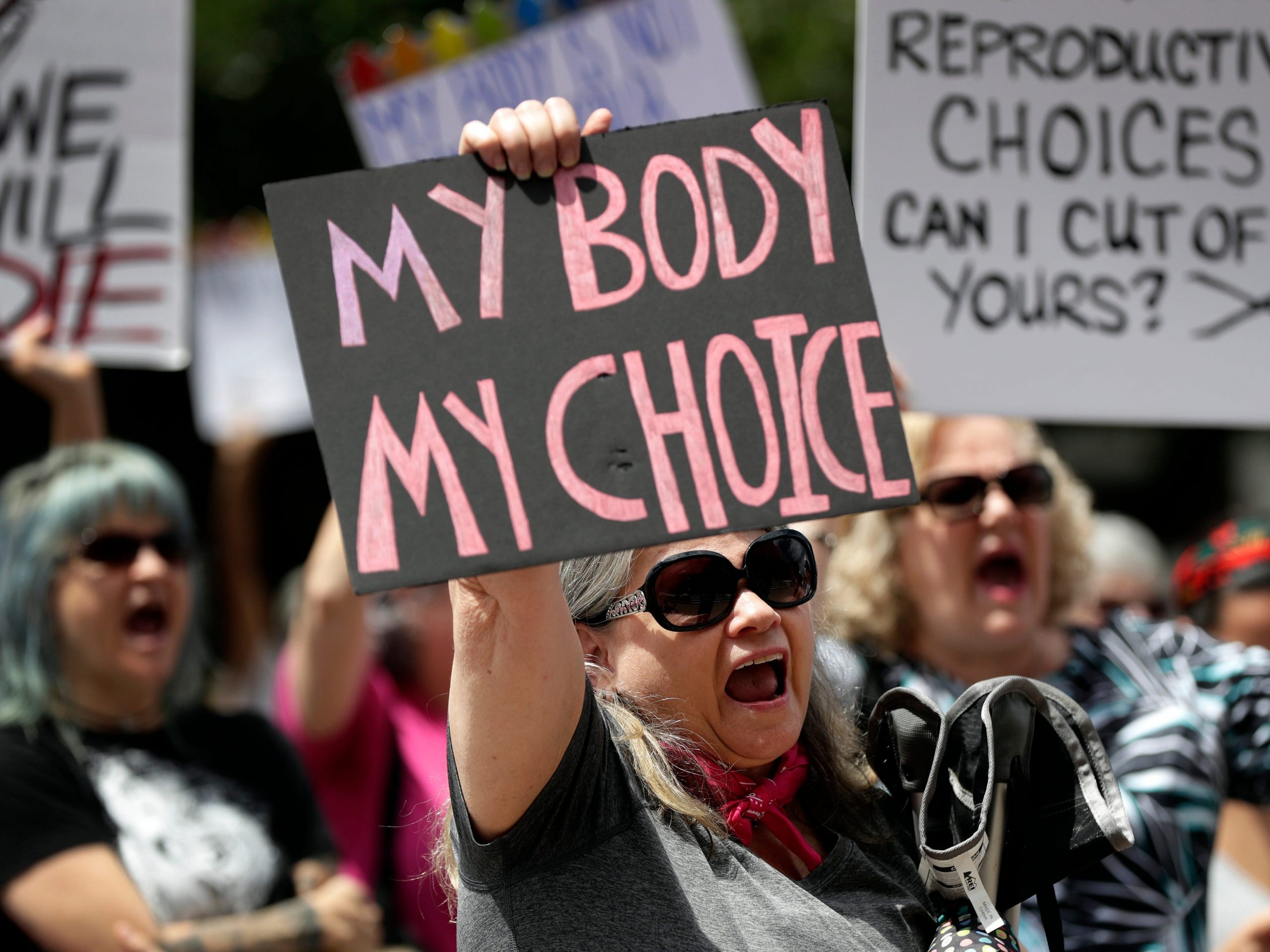 Protesters hold signs at an abortion rally at the Texas State Capitol in 2019.