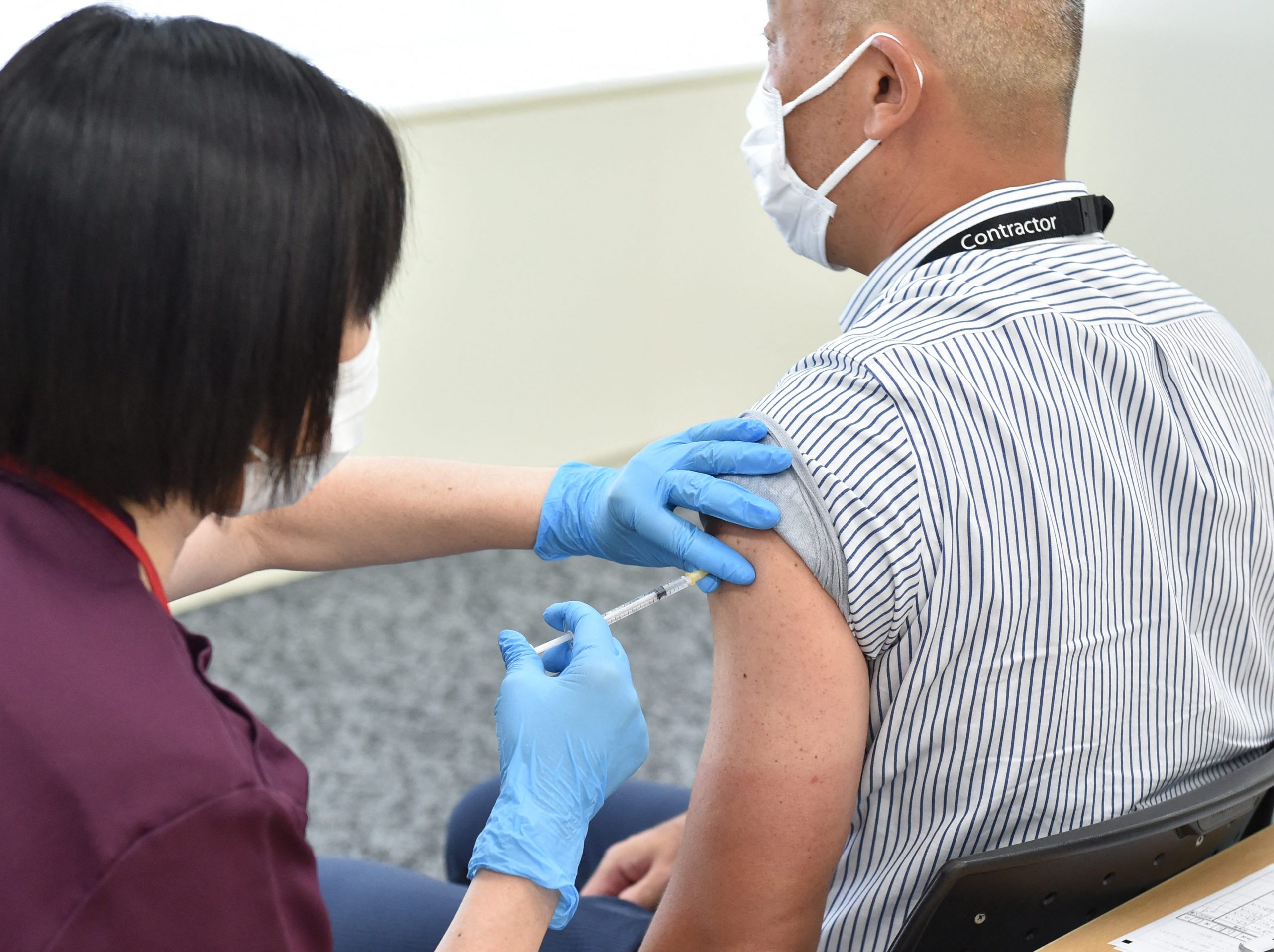 Japanese man receiving moderna vaccine