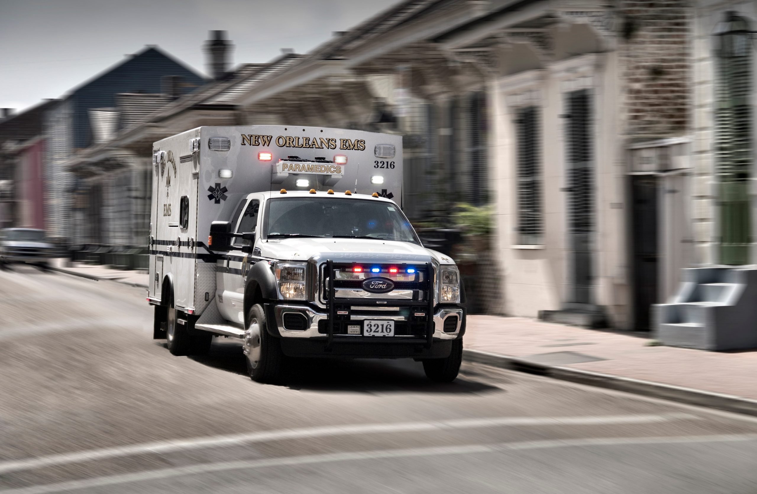 A New Orleans ambulance drives in the French Quarter