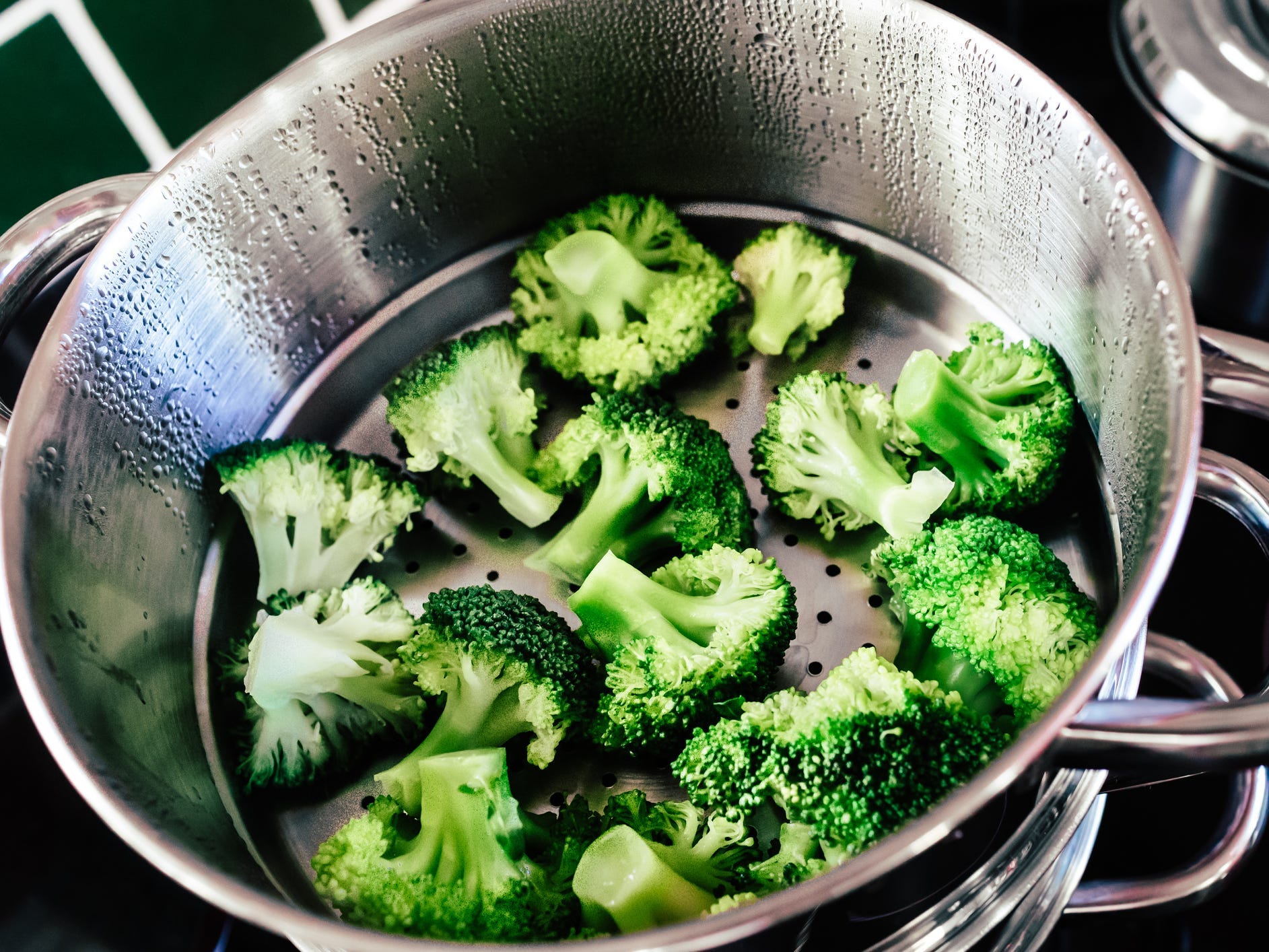 Broccoli in a steamer basket.