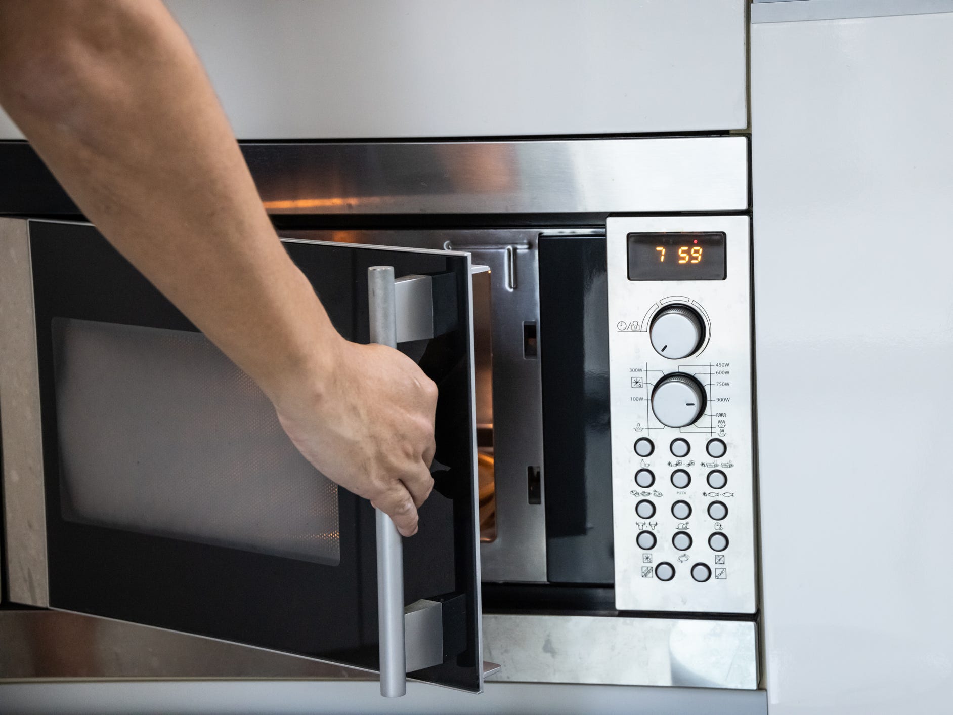 Shot of someone opening up a microwave.