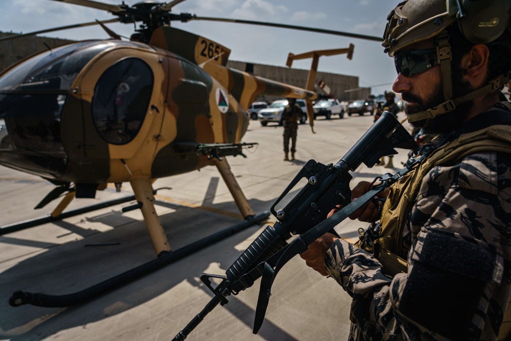 Taliban fighters stand ready as the militant group secure the Hamid Karzai International Airport, in the wake of the American forces completing their withdrawal from the country in Kabul, Afghanistan, Tuesday, Aug. 31, 2021.