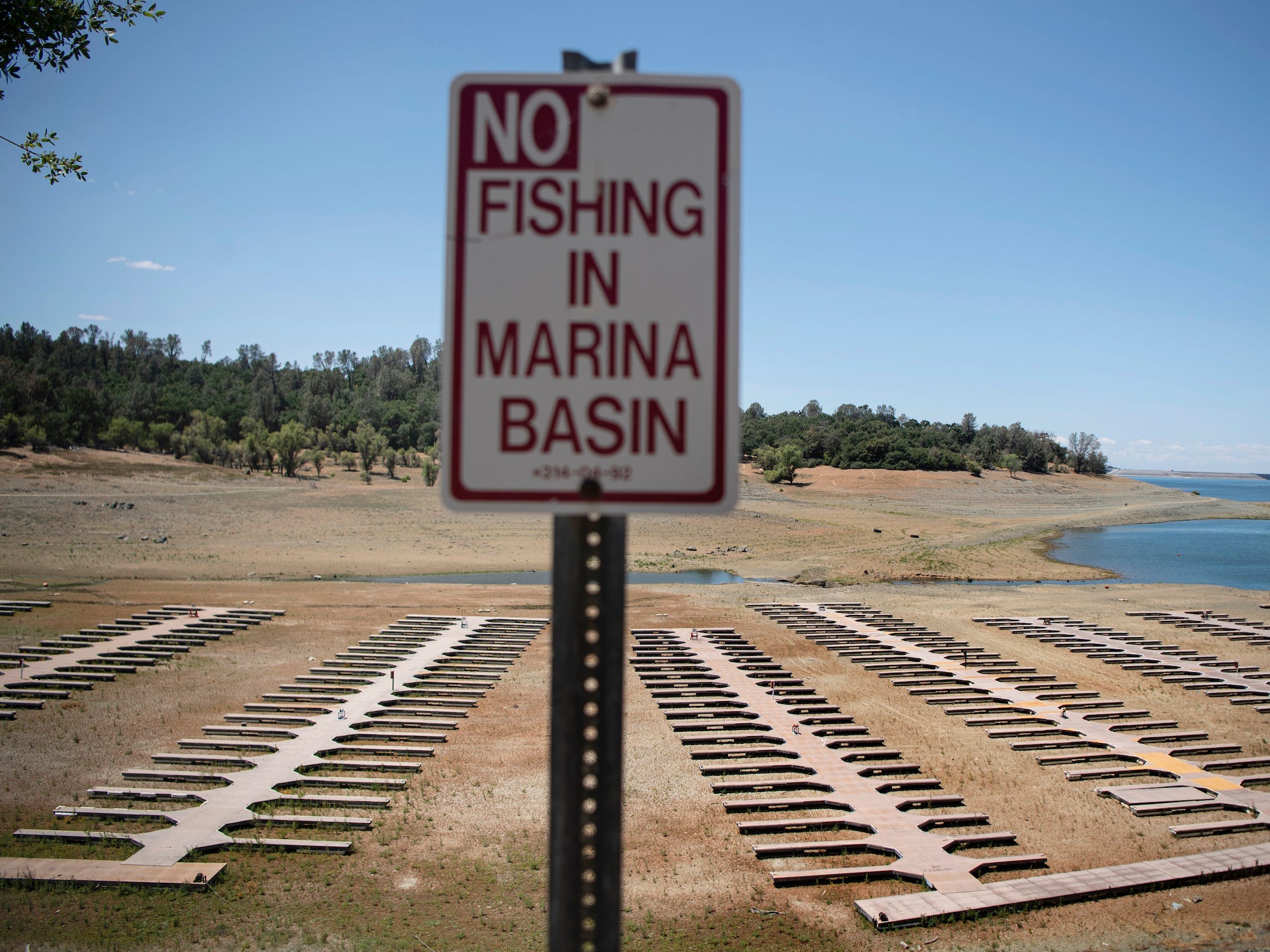 Empty boat docks sit on dry land at the Browns Ravine Cove area of drought-stricken Folsom Lake, currently at 37% of its normal capacity, in Folsom, Calif., Saturday, May 22, 2021.