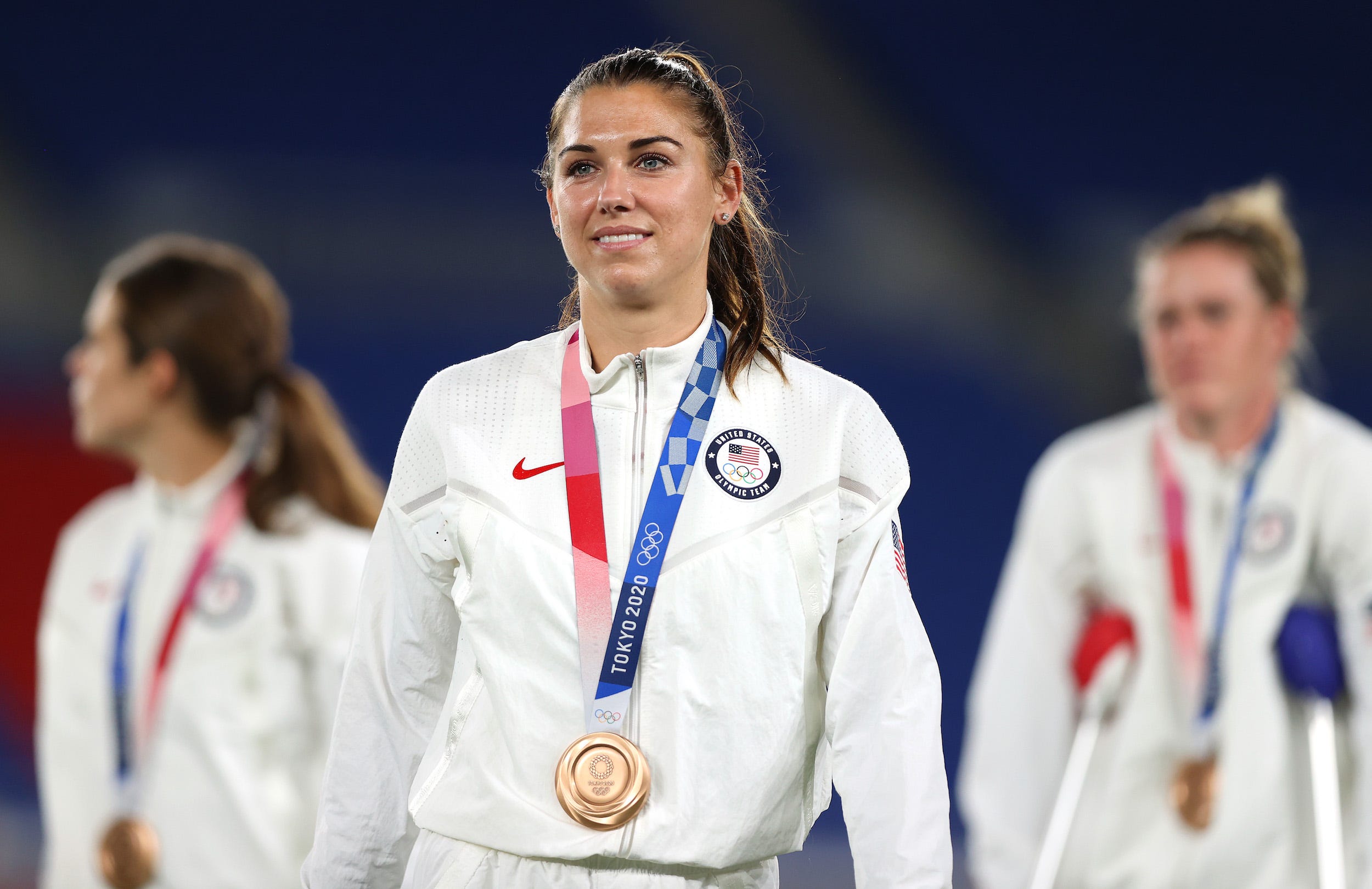 Alex Morgan dons her bronze medal at the Tokyo Olympics.