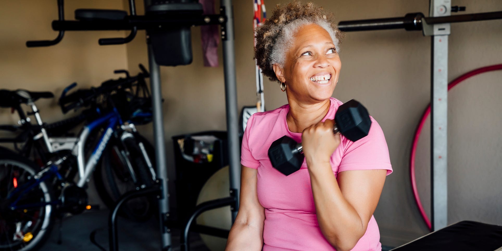 older woman lifting weights and dumbbells