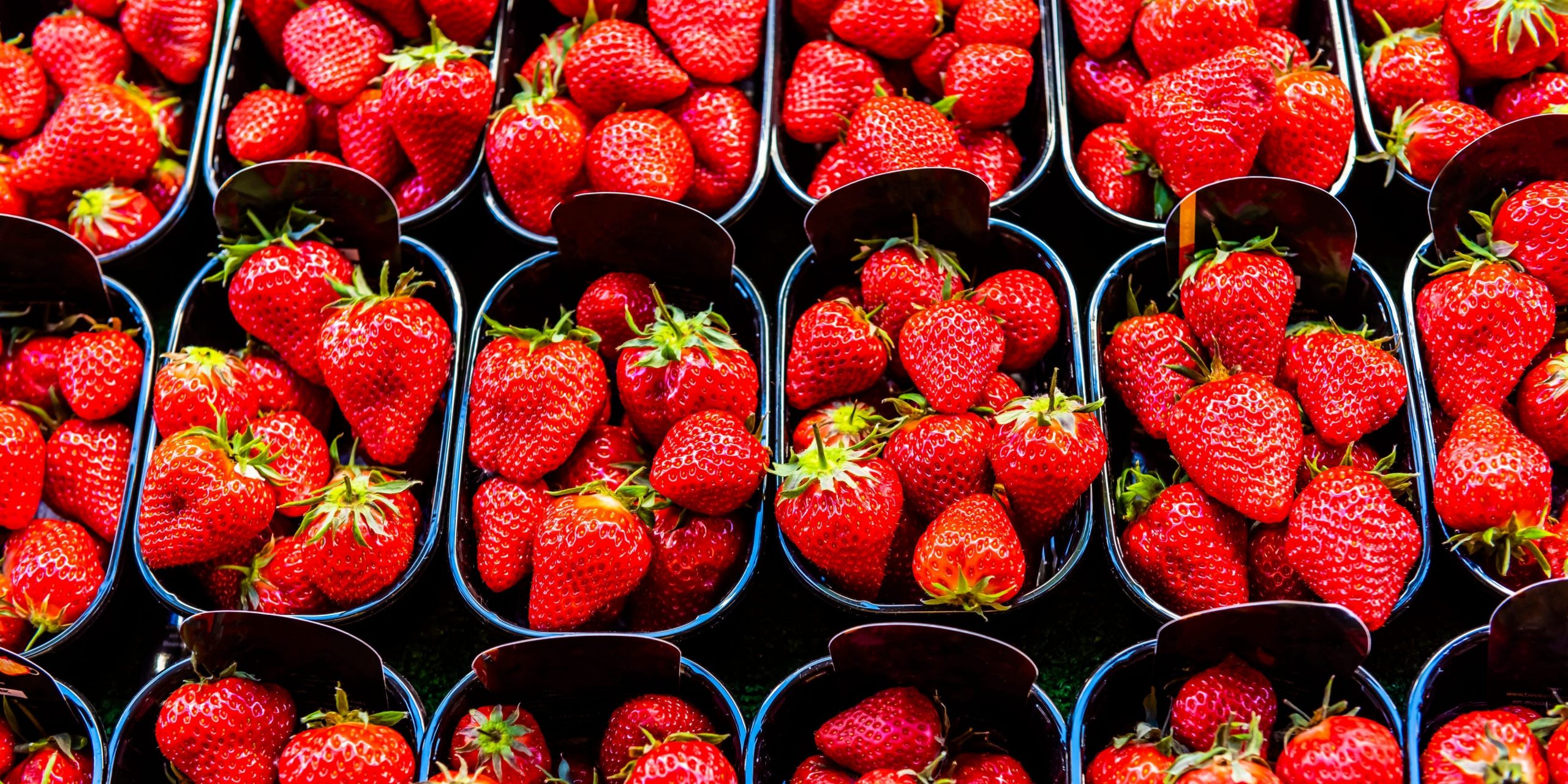 Strawberries for sale at Rue Cler street market, Paris, France.