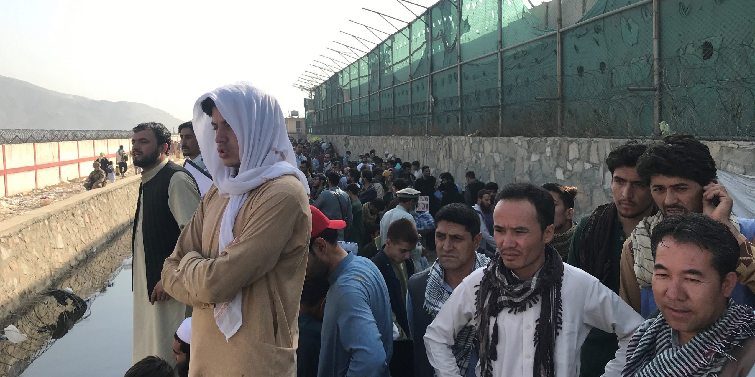 Afghans gather near a gate of Kabul airport