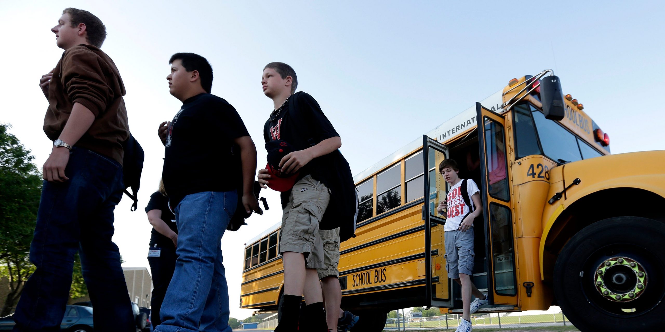 Students exit a school bus.