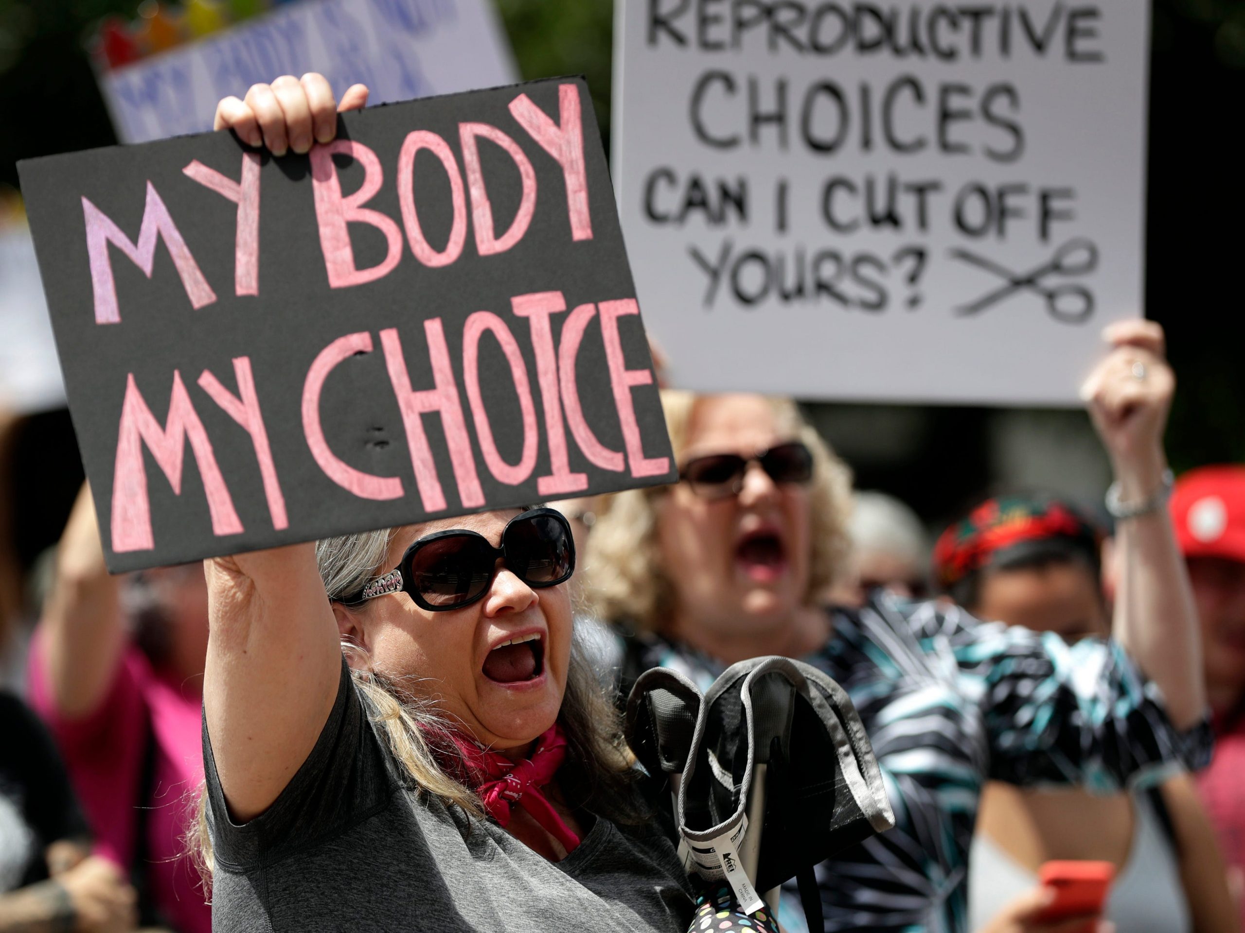 Protesters hold signs at an abortion rally at the Texas State Capitol in 2019.