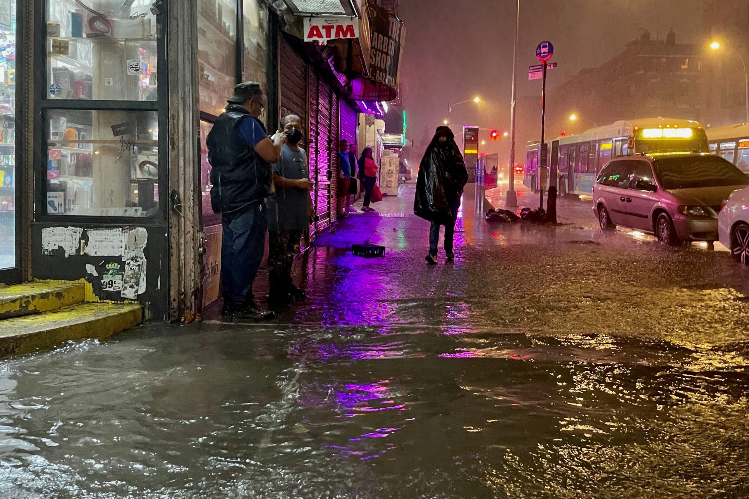 People make their way in rainfall from the remnants of Hurricane Ida on September 1, 2021, in the Bronx borough of New York City.