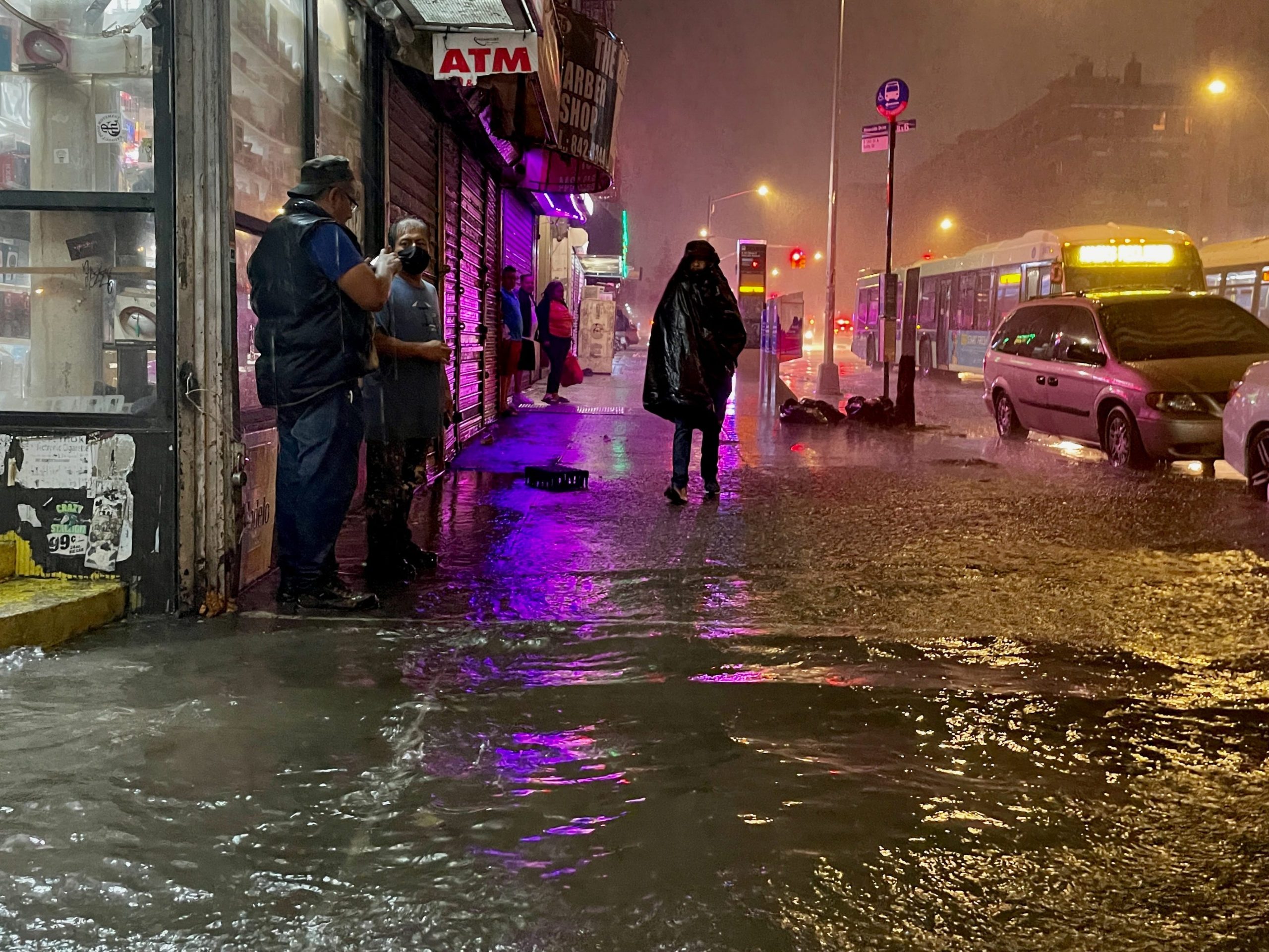 People make their way in rainfall from the remnants of Hurricane Ida on September 1, 2021, in the Bronx borough of New York City.