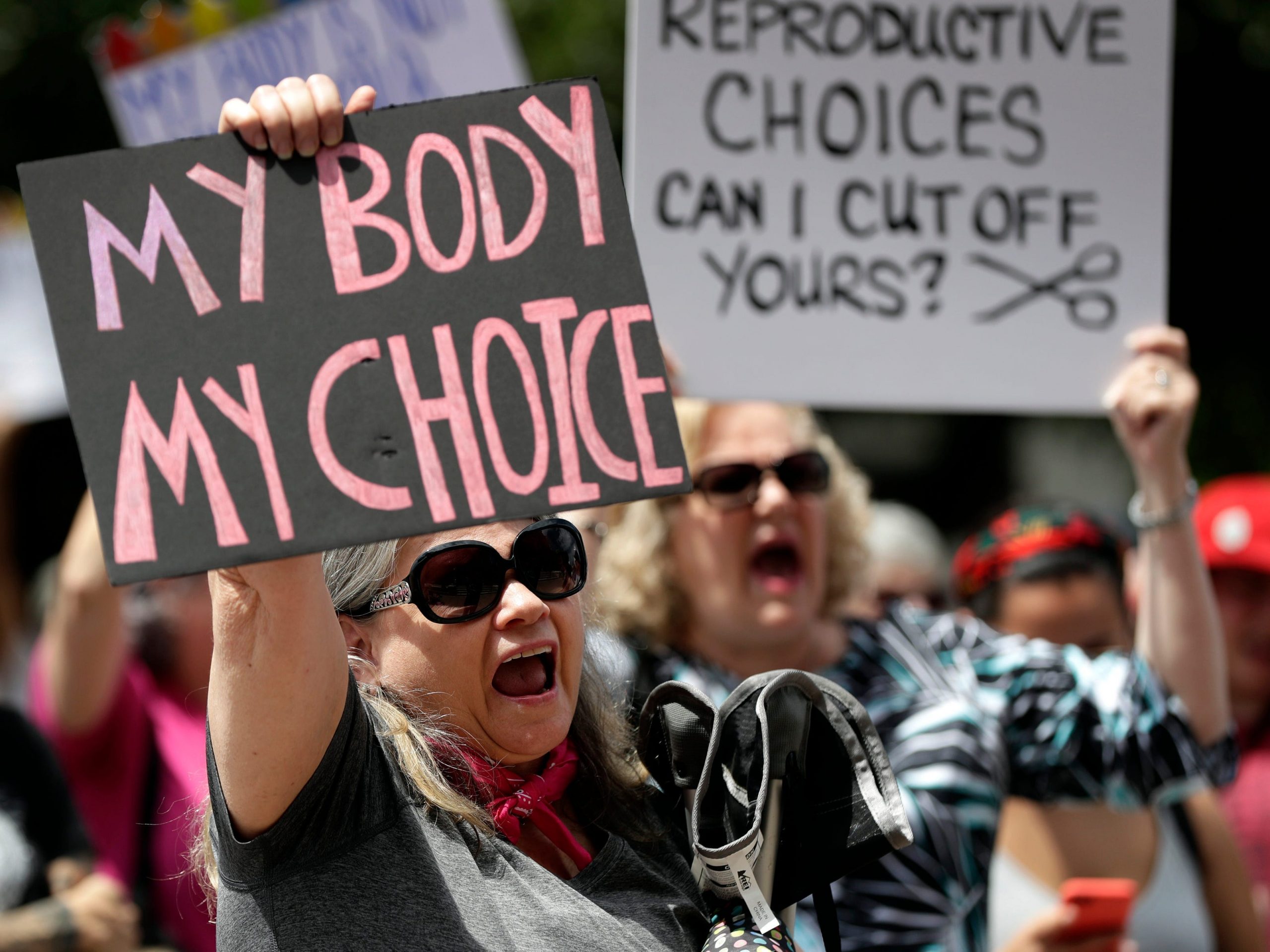 Protesters hold signs at an abortion rally at the Texas State Capitol in 2019.