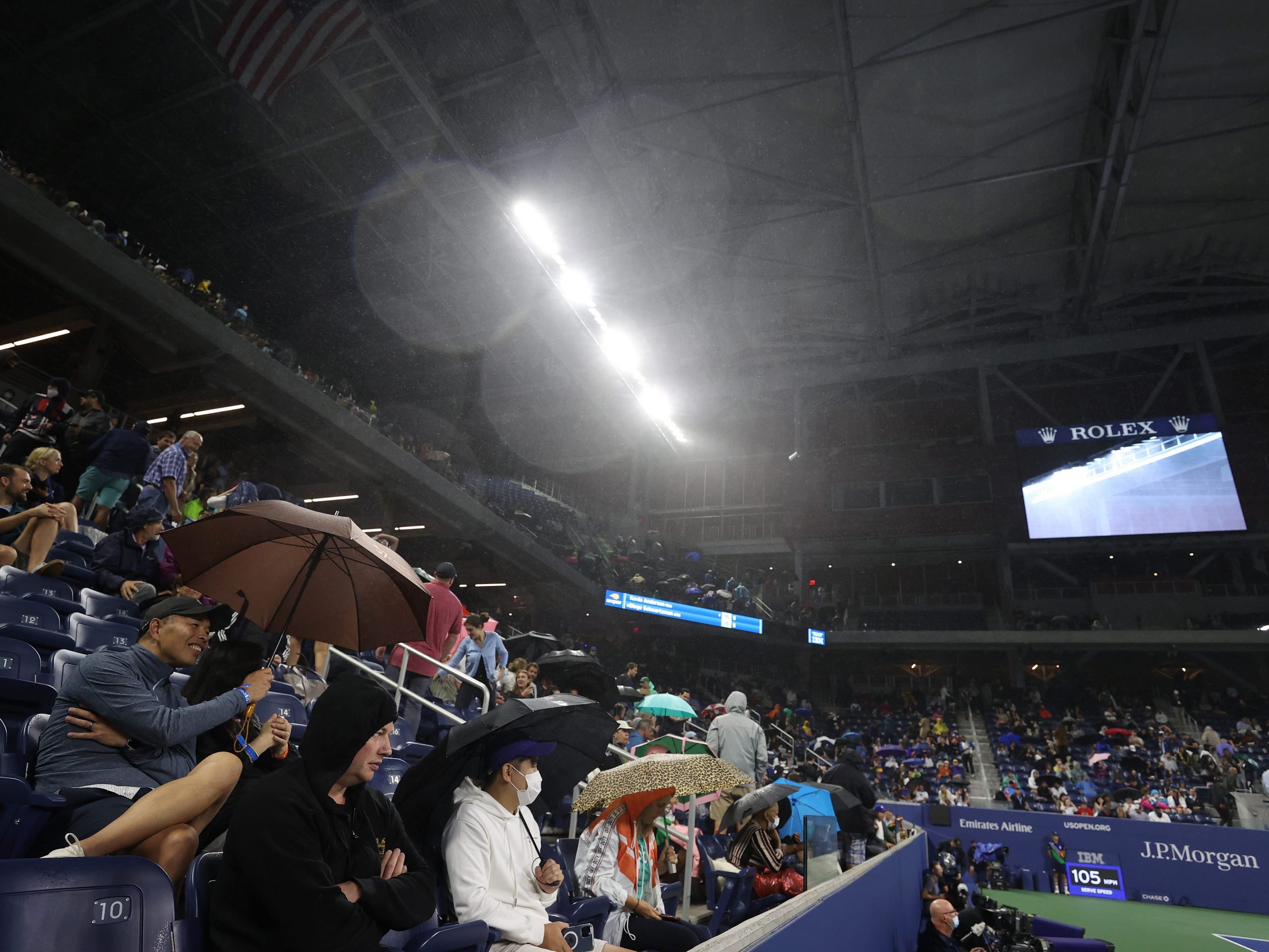 Rain enters the court through the outer openings of the roof causing a delay during the match