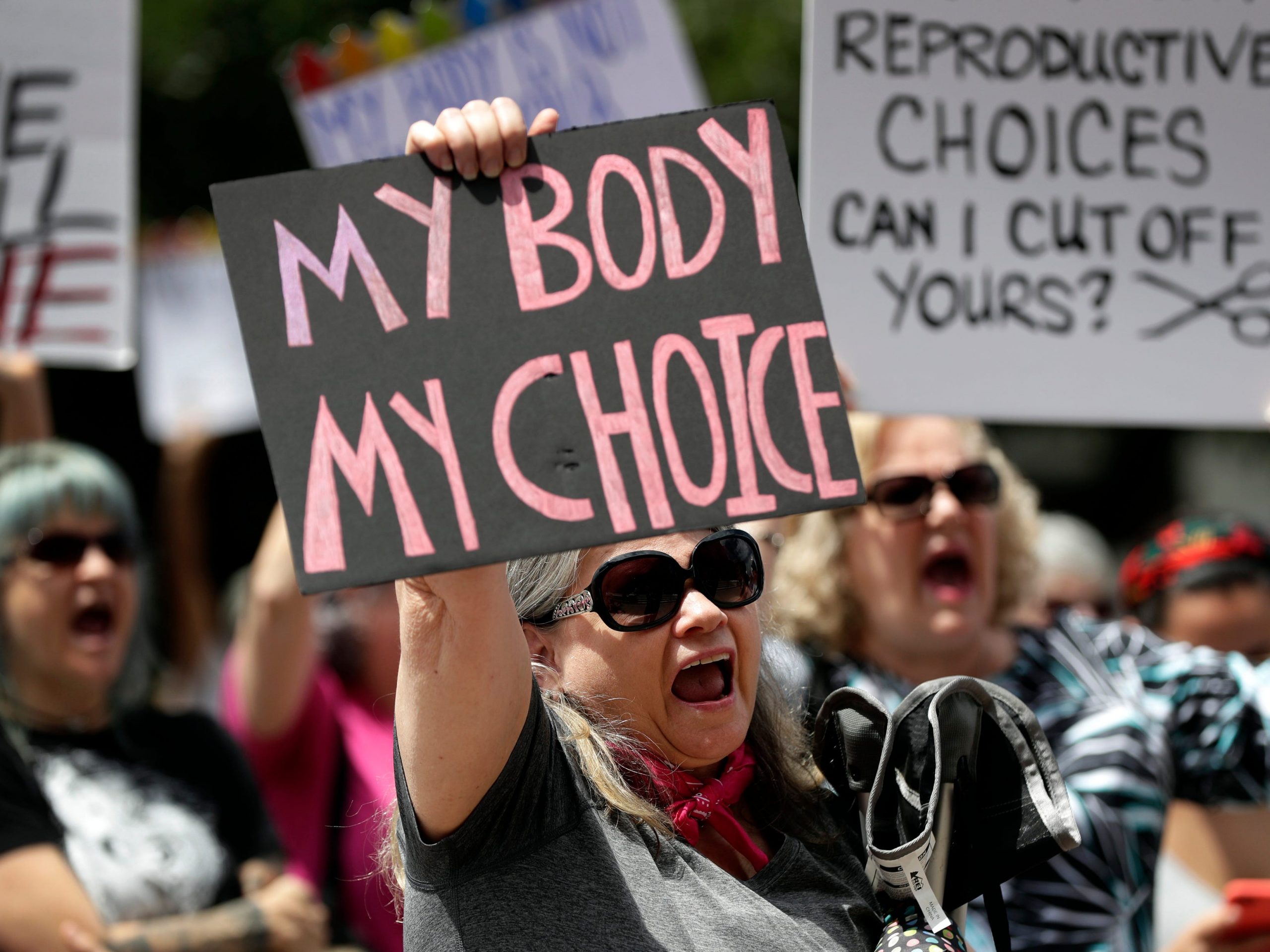 Protesters hold signs at an abortion rally at the Texas State Capitol in 2019.