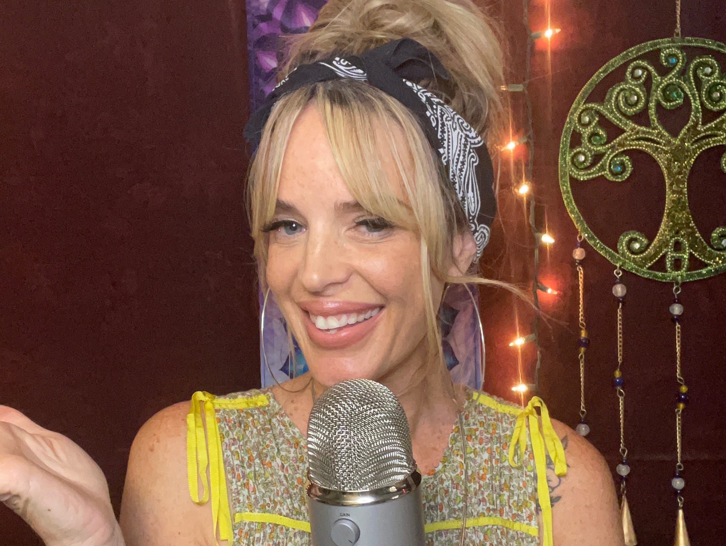 Lucy Davis smiles with the microphone she uses for ASMR.