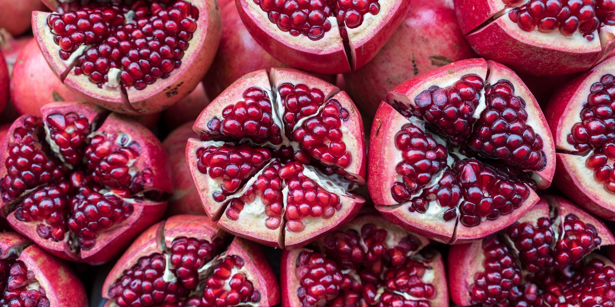 Many pomegranates cut into sections