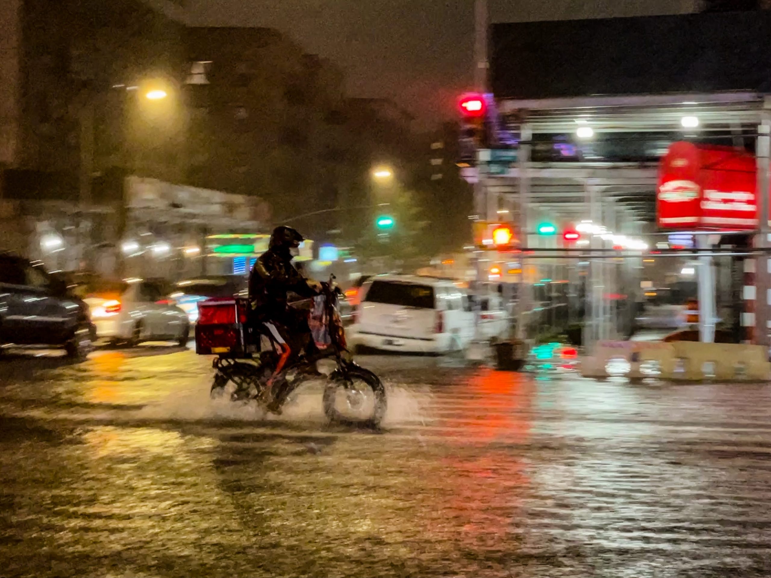 A delivery worker makes their way in the rainfall from Hurricane Ida during a flood on Intervale Avenue on September 1, 2021, in the Bronx borough of New York City. The once category 4 hurricane passed through New York City, dumping 3.15 inches of rain in the span of an hour at Central Park.