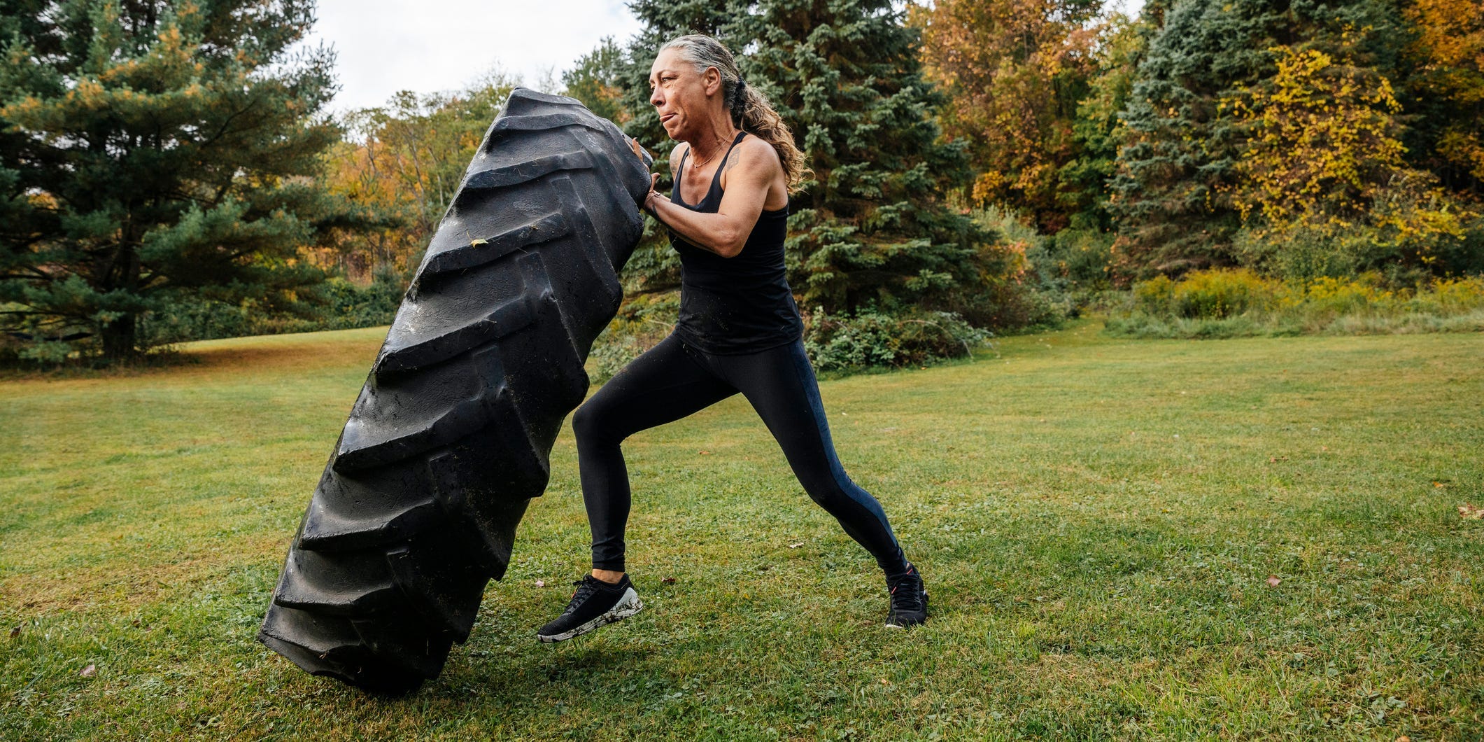 woman pushing tire during a strength workout