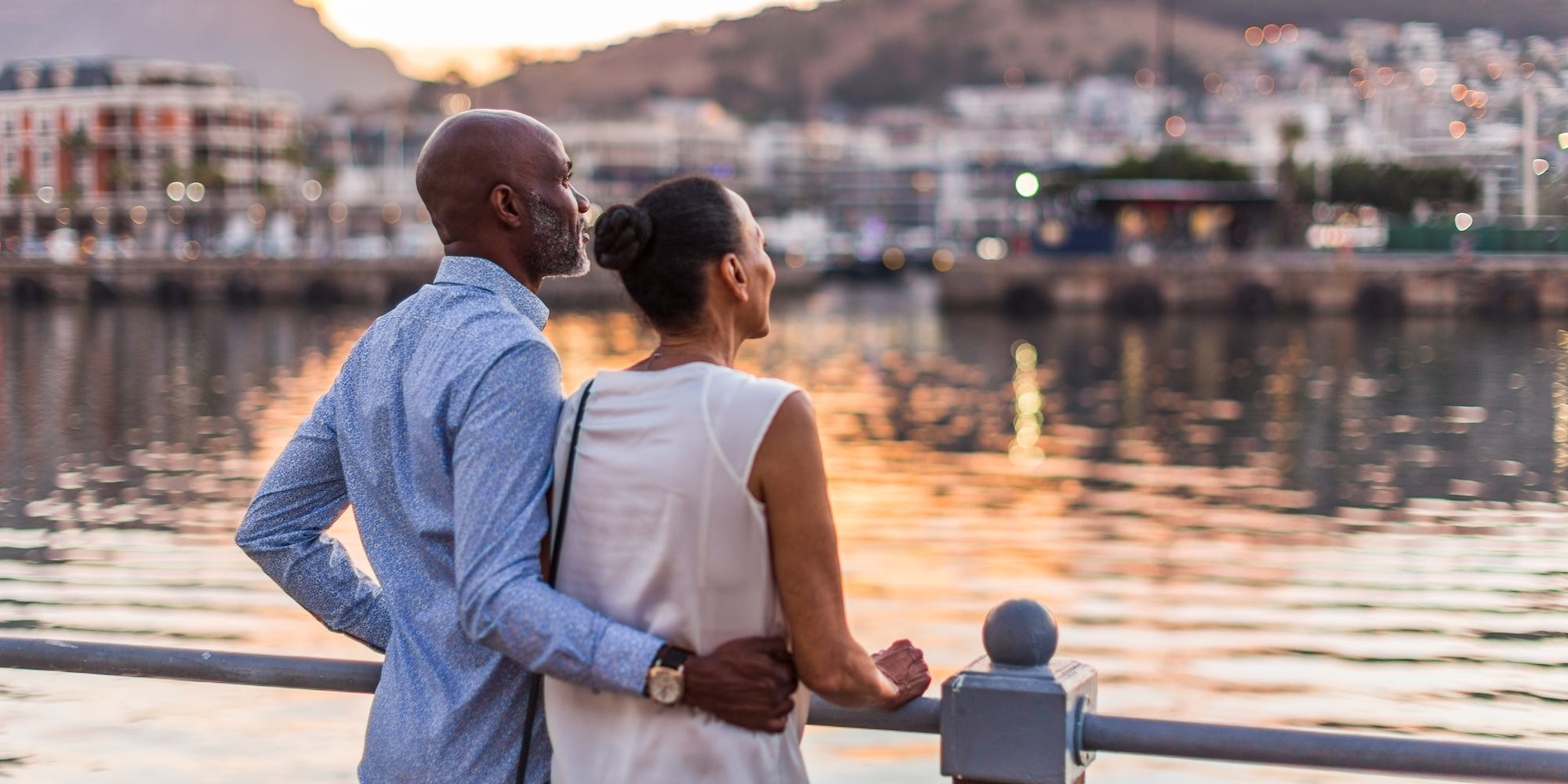 A couple standing together looking at the skyline.